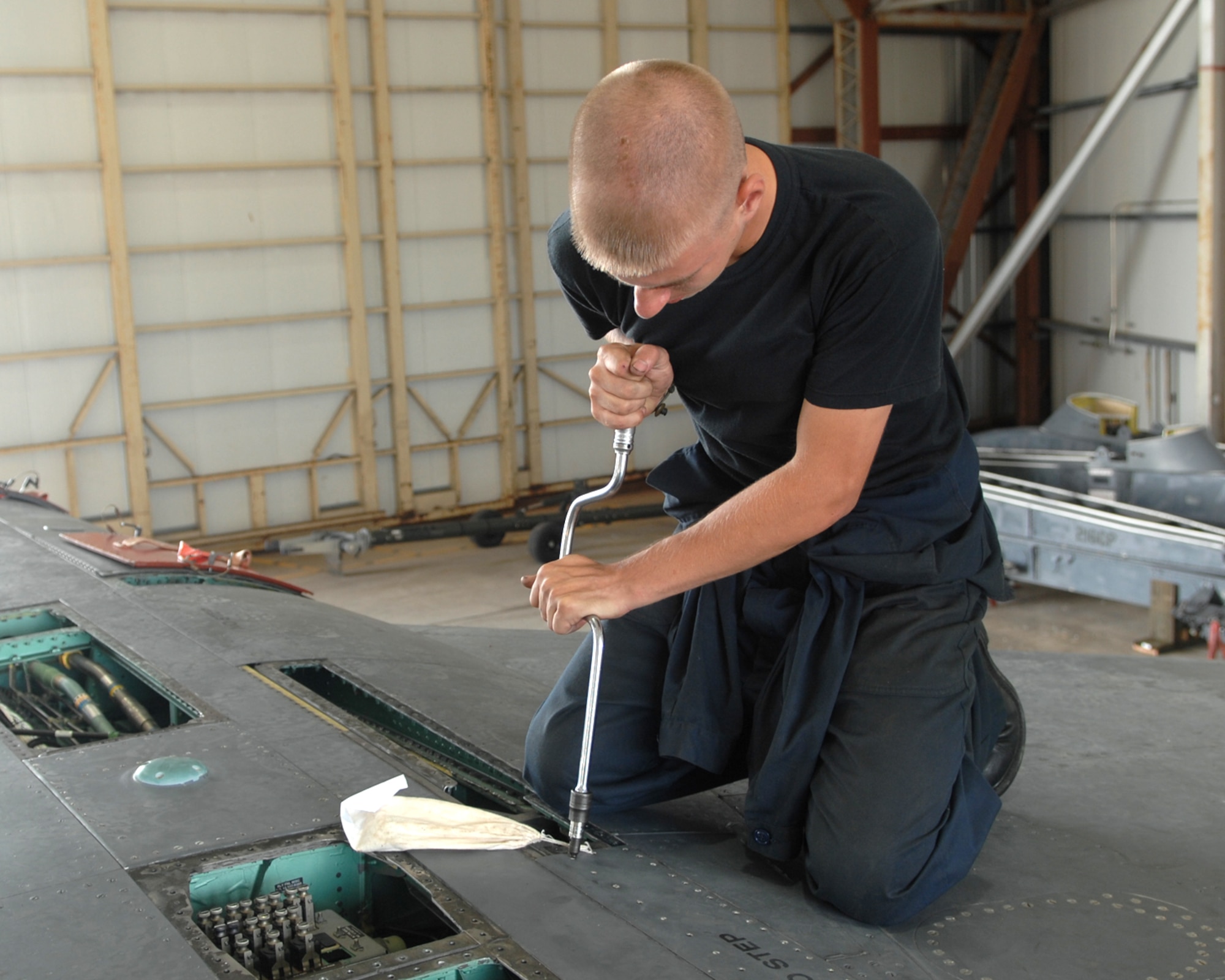 ANDERSEN AIR FORCE BASE, Guam - Airman 1st Class Anthony Easterday, 389th Expeditionary Aircraft Maintenance Squadron, performs maintenance on an F-15E Strike Eagle during its phase maintenance Aug. 14. A phase inspection is a group of maintenance squadron flights working together towards a common goal, which is the completion of the inspection, a phase inspection is a miniature overhaul for the aircraft that is performed every 400 flight hours. (U.S. Air Force photo by Airman 1st Class Cory Todd)
