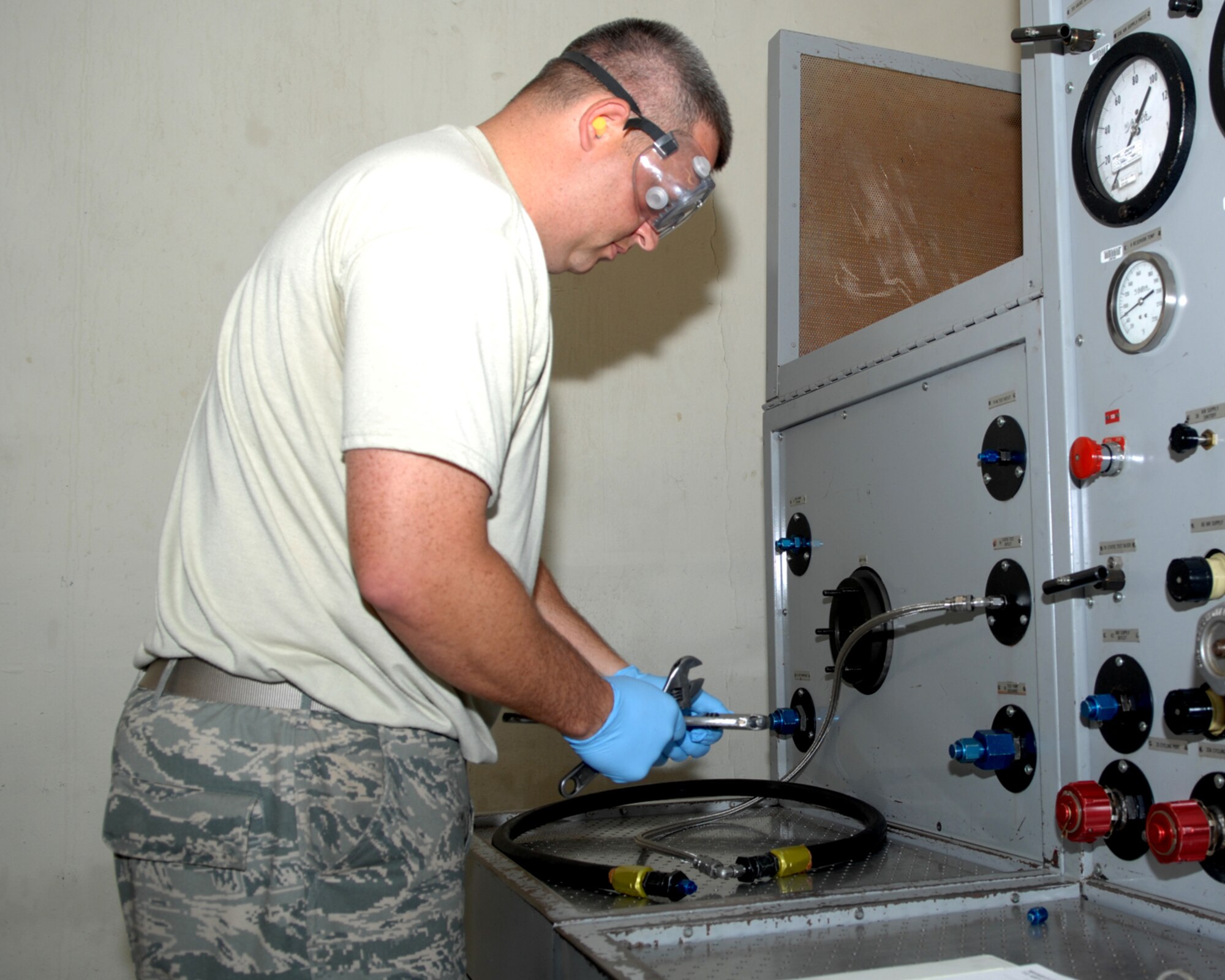 ANDERSEN AIR FORCE BASE, Guam - Staff Sgt. David Fiscus, 389th Expeditionary Aircraft Maintenance Squadron, inspects a hydraulic hose Aug. 14. Sergeant Fiscus works in the hydraulics back shop deployed here from Mountain Home AFB, Idaho. The hydraulics back shop maintains on and off equipment pneumatic, hydraulic systems and their components they also maintain hydraulic test stands, pumping units and associated components. (U.S. Air Force photo by Airman 1st Class Cory Todd)
