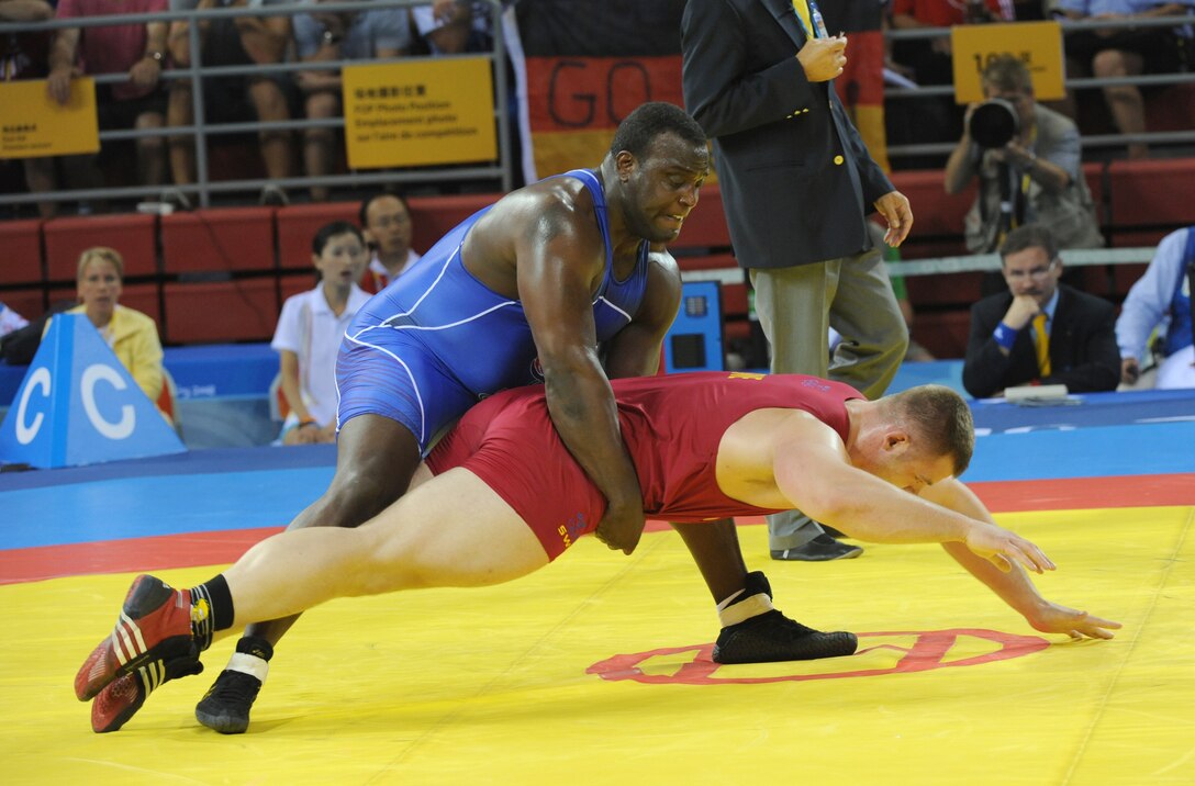 U.S. Army Staff Sgt. Dremiel Byers lifts Sweden's Jalmar Sjoberg during a quarterfinal match of the 2008 Olympic Greco-Roman 120-kilogram tournament Aug. 14, 2008, in Beijing. 