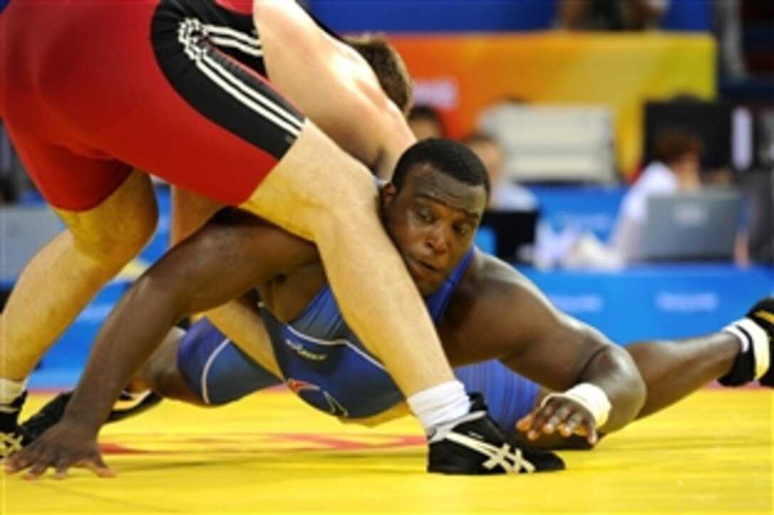 U.S. Army World Class Athlete Program Staff Sgt. Dremiel Byers avoids getting lifted by Ukraine's Oleksandr Chernetskyi en route to a 1-1, 2-0 qualification victory in the Olympic Greco-Roman 120-kilogram wrestling tournament, Aug. 14, 2008, at the China Agricultural University Gymnasium in Beijing. 


