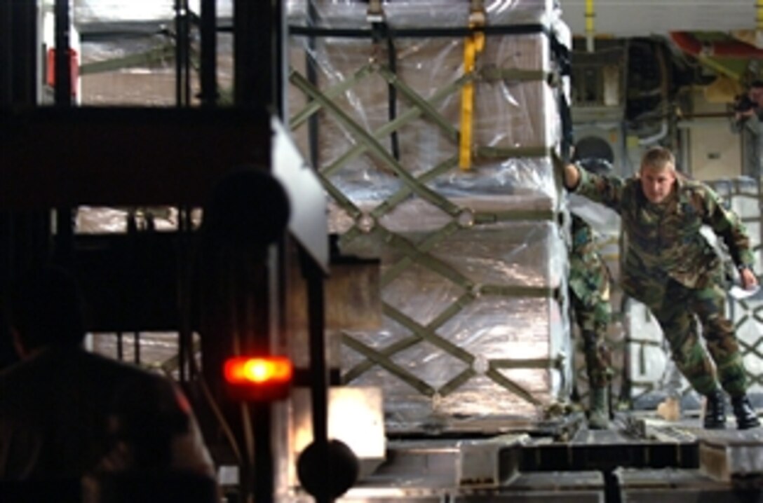 U.S. Air Force Staff Sgt. Chris Broegemueller helps push out the first of 16 pallets of supplies aboard an Air Force C-17 Globemaster III for the people of Georgia from Ramstein Air Base, Germany, Aug. 13, 2008. The humanitarian assistance delivery consisted of $1 million in U.S.-donated medical supplies, blankets, sleeping bags and bed sheets. The delivery was a joint service effort between U.S. Army Europe soldiers and airmen representing both U.S. Air Forces in Europe and Air Mobility Command