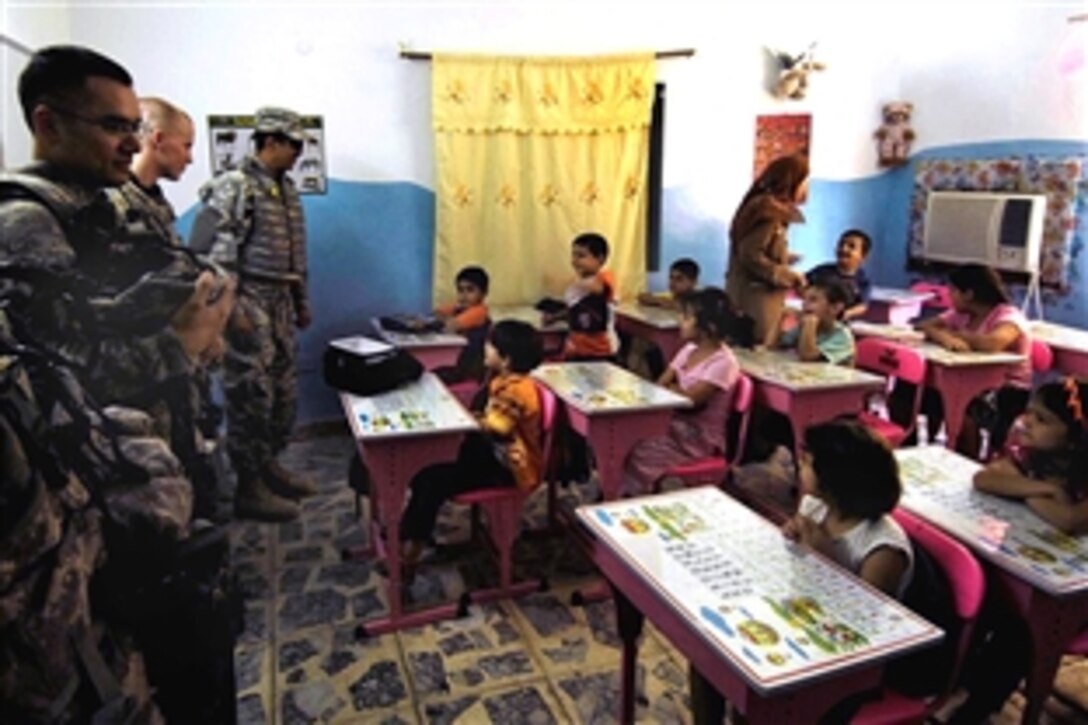 U.S. Army soldiers visit children in a classroom at Alethar Elementary School, in Amariyah, Iraq, Aug. 12, 2008. The soldiers are assigned to the 4th Infantry Division's Troop C, 10th Cavalry. 
