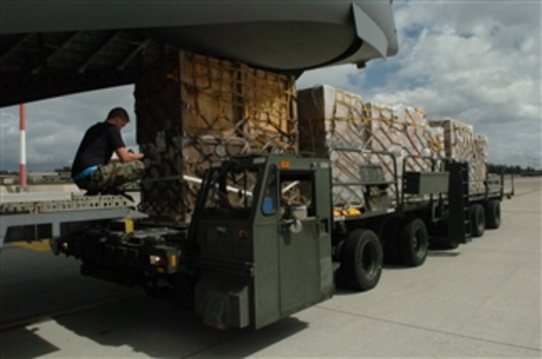 A U.S. airman from the 793rd Air Mobility Squadron moves humanitarian supplies into position for loading onto a cargo aircraft at Ramstein Air Base in Germany on Aug. 13, 2008. U.S. soldiers and airmen have worked 36 hours to palletize more than 75,000 pounds of emergency shelter items and medical supplies for delivery to areas in Georgia affected by the current conflict.  