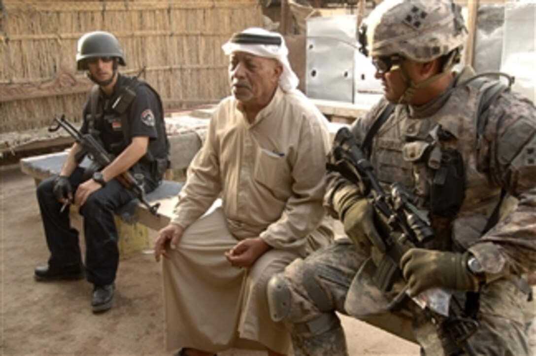 U.S. Army Sgt. 1st Class Ray Maiava speaks with a local resident while conducting a combined patrol with Iraqi Police in Ha'Teen, Baghdad, Iraq, on Aug. 4, 2008.  Maiava serves as Platoon Sgt., in the 2nd Platoon, Bravo Battery, 4th Battalion, 42nd Field Artillery, 1st Brigade Combat Team, 4th Infantry Division.  