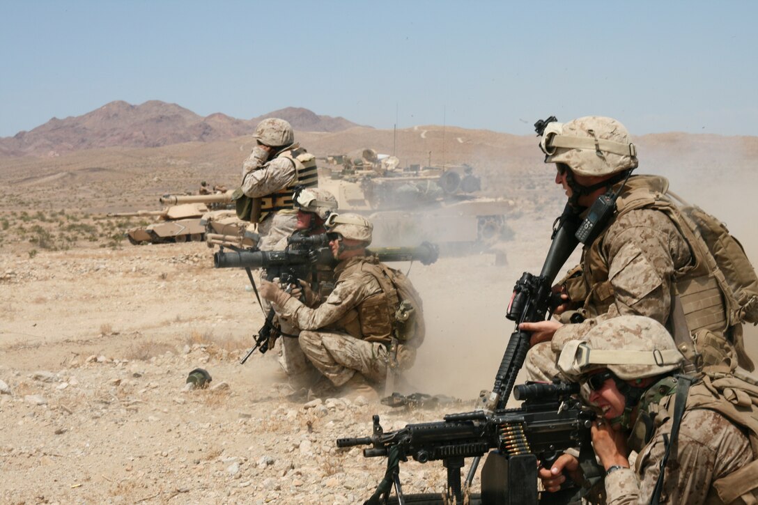 Supported by M1A1 Abrams tanks from 1st Tank Battalion, 1st Marine Division, the infantrymen of 2nd Platoon, Company F, 2nd Battalion, 25th Marine Regiment, assault an enemy objective during a live-fire combined arms exercise Aug. 14 at Marine Corps Air Ground Combat Center in Twentynine Palms, Calif.