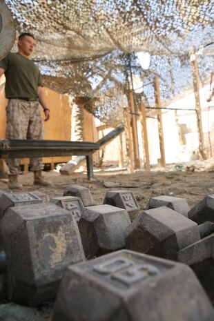 Marines with Headquarters Company, Regimental Combat Team 1, spend time exercising at a gym just outside their offices at Camp Fallujah, Iraq, Aug. 14. (Official Marine Corps photo by Cpl. Chris T. Mann)