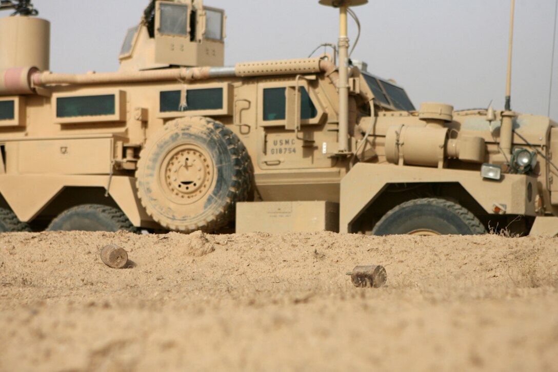Two fragmentation mines lie just feet away from a roadway Aug. 14 that Coalition forces frequently travel in western al-Anbar province, Iraq. Six mines were discovered by Route Clearance Platoon, Company A, 3rd Combat Engineer Battalion, Regimental Combat Team 5, as they marked two minefields along the Iraq/Syrian border.  Once the first minefield was properly marked to NATOâ??s standards, the combat engineers detonated the six fragmentation mines.