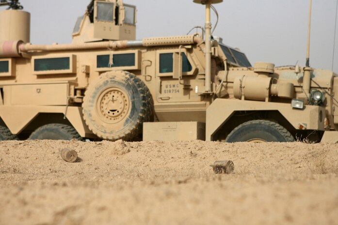 Two fragmentation mines lie just feet away from a roadway Aug. 14 that Coalition forces frequently travel in western al-Anbar province, Iraq. Six mines were discovered by Route Clearance Platoon, Company A, 3rd Combat Engineer Battalion, Regimental Combat Team 5, as they marked two minefields along the Iraq/Syrian border.  Once the first minefield was properly marked to NATOâ??s standards, the combat engineers detonated the six fragmentation mines.