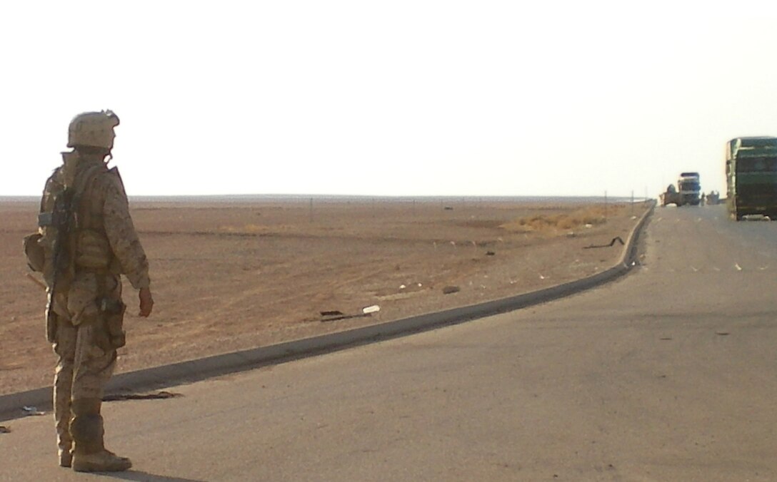 Sgt. Cody Morgan, 24, from Tombstone, Ariz., who is an infantry Marine with Mobile Assault Platoon, Regimental Combat Team 5,  posts security as vehicles approach the vehicle checkpoints on a highway in al-Anbar province, Iraq, Aug. 15.  The Marines with the platoon, known as Grizzly Mobile , usually run escort missions for command staff within Regimental Combat Team 5.  However, the platoon recently assisted 2nd Light Armored Reconnaissance Battalion, RCT-5 in desert operations that included vehicle checkpoints, patrols and census gathering.::r::::n::