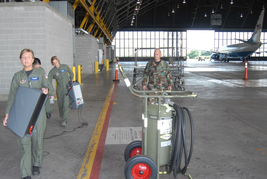 The maintenance hangar was the scene of many hours of preparation as Tech. Sgt. Gerald Sonnenberg (right)  from the 932nd Airlift Wing public affairs, and Staff Sgt. Melissa Calabres (left) along with additional aeromedical evacuation specialists, stepped up to ready equipment and make preprations for the "AE JAMBOREE".  This is a special aeromedical evacuation event designed to give training on a variety of airplanes including the KC-135, the C-130 and the C-17.   The wing's C-40 sits at right.  Photo by Maj. Stan Paregien