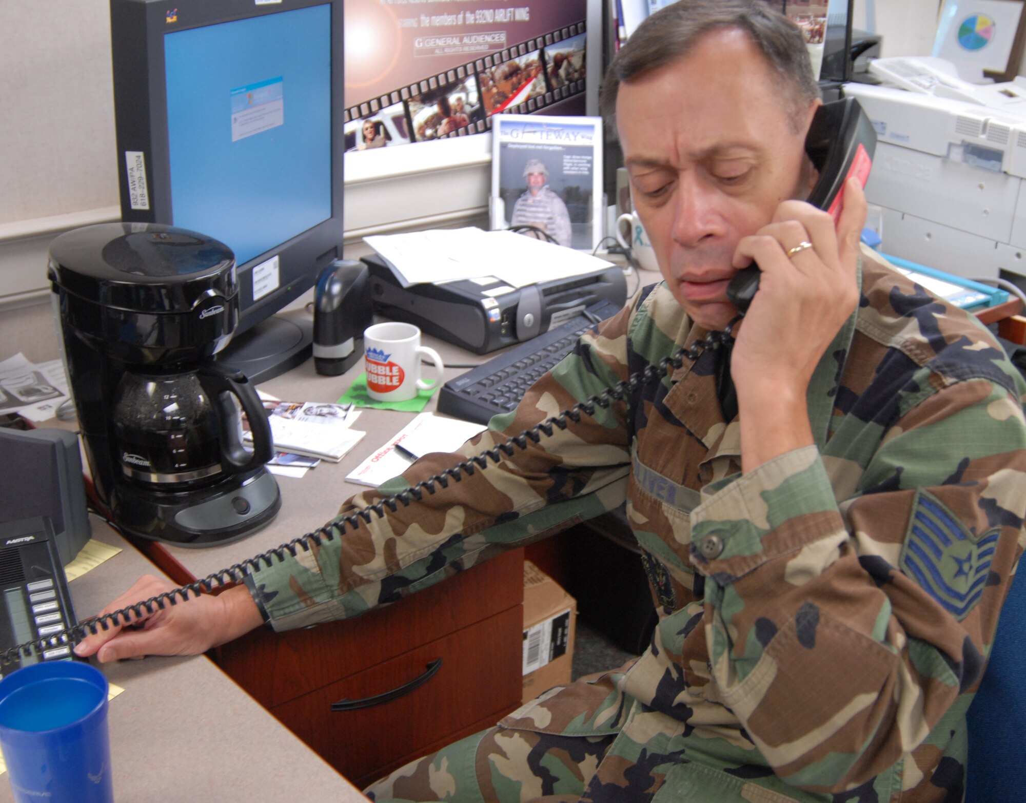 932nd Airlift Wing reporter Tech Sgt. Dan Oliver takes a call on a community oriented feature news story during the recent Air Force Reserve Command's drill weekend.  He helps write copy for the public affairs office newspaper and webpage located at:  http://www.932aw.afrc.af.mil/  Photo by Tech Sgt. Gerald Sonnenberg