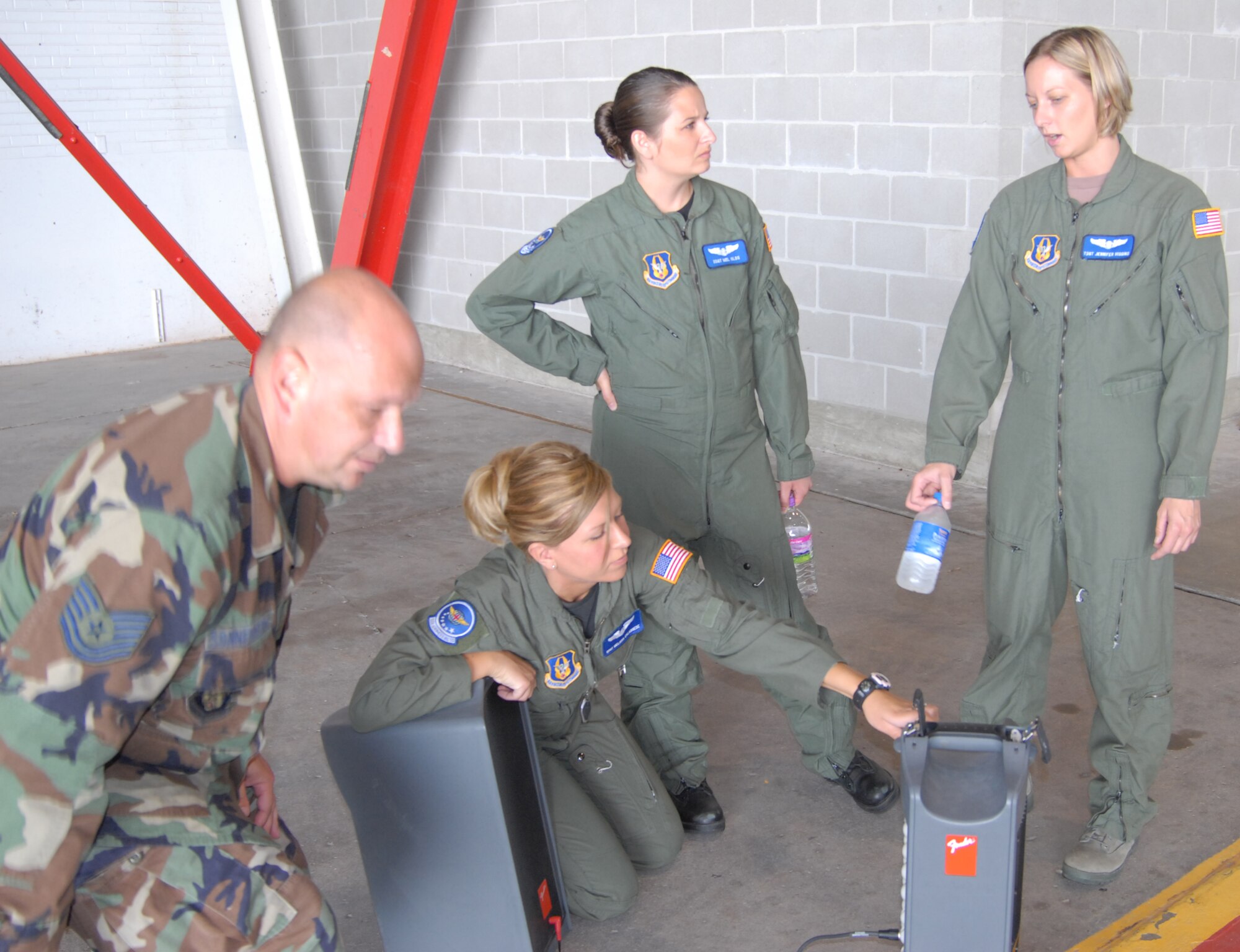 Tech. Sgt. Gerald Sonnenberg (left), from the 932nd Airlift Wing public affairs, and aeromedical evacuation specialists, stepped up to set up equipment and make preprations for the "AE JAMBOREE", an aeromedical evacuation event designed to give training on a variety of airplanes including the KC-135, the C-130 and the C-17. The event is hosted this year by the 375th Airlift Wing and 932nd Airlift Wing at Scott Air Force Base. Other units arrived today from as far as Minnesota, California and Georgia. Photo by Maj. Stan Paregien