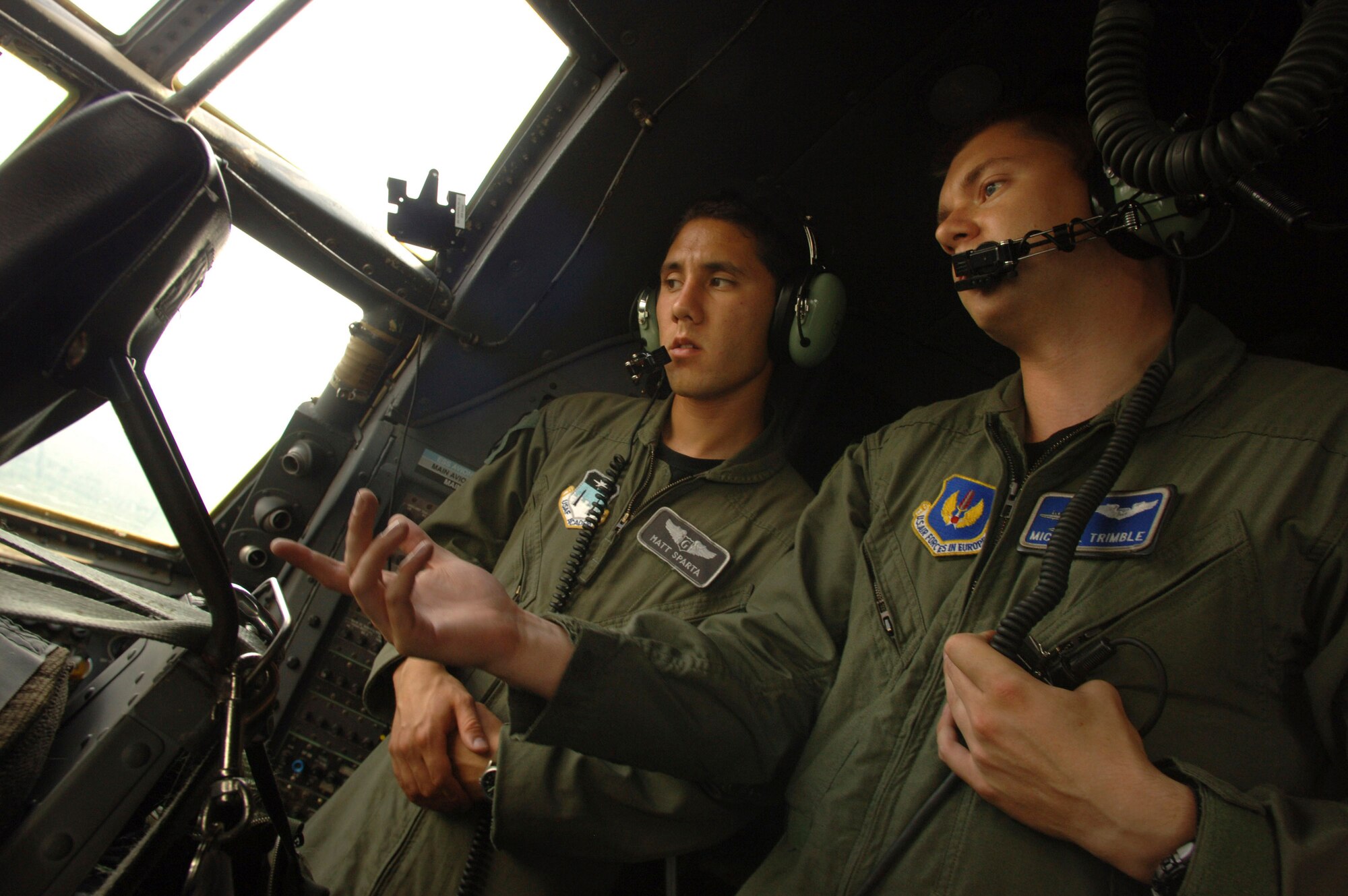 C-130 Hercules navigator Capt. Michael Trimble (right) discusses the capabilities of the aircraft with Air Force Academy Cadet 1st Class Matt Sparta during an airdrop sortie over eastern Germany as part of a hands-on, job shadow program called Operation Air Force. Captain Trimble is assigned to the 37th Airlift Squadron at Ramstein Air Base, and Cadet Sparta, along with 80 other cadets, spent three weeks at Ramstein AB observing various squadron operations.  (U.S. Air Force photo/Master Sgt. Scott Wagers) 