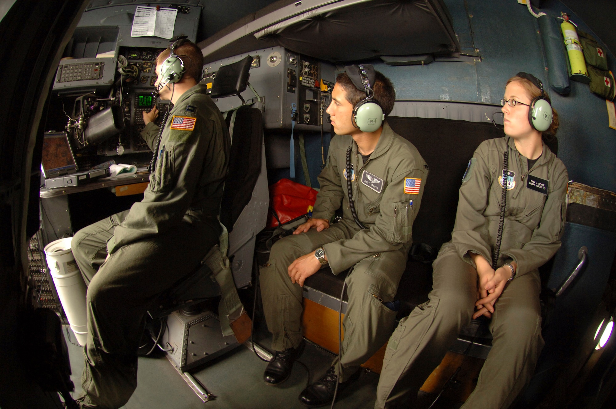 During a C-130 Hercules airdrop mission over eastern Germany, Air Force Academy Cadet 1st Class Matt Sparta (center) and Cadet 2nd Class Erin Keane watch how navigator Capt. Michael Trimble keeps the Hercules on course as part of a hands-on job shadow program called Operation Air Force. (U.S. Air Force photo/Master Sgt. Scott Wagers) 