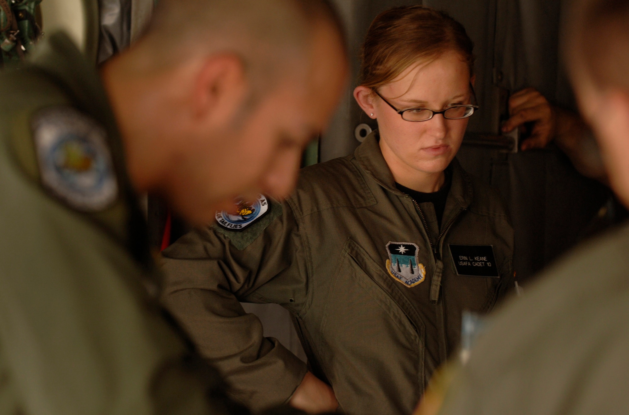 Before an airdrop mission over eastern Germany, Air Force Academy Cadet 2nd Class Erin Keane observes the preflight duties of C-130 Hercules loadmasters, Staff Sgt. Dan Insurriaga and Senior Airman Matthew Merkely.  Cadet Keane was participating in a hands-on,  job shadow program called Operation Air Force. (U.S. Air Force photo/Master Sgt. Scott Wagers)
