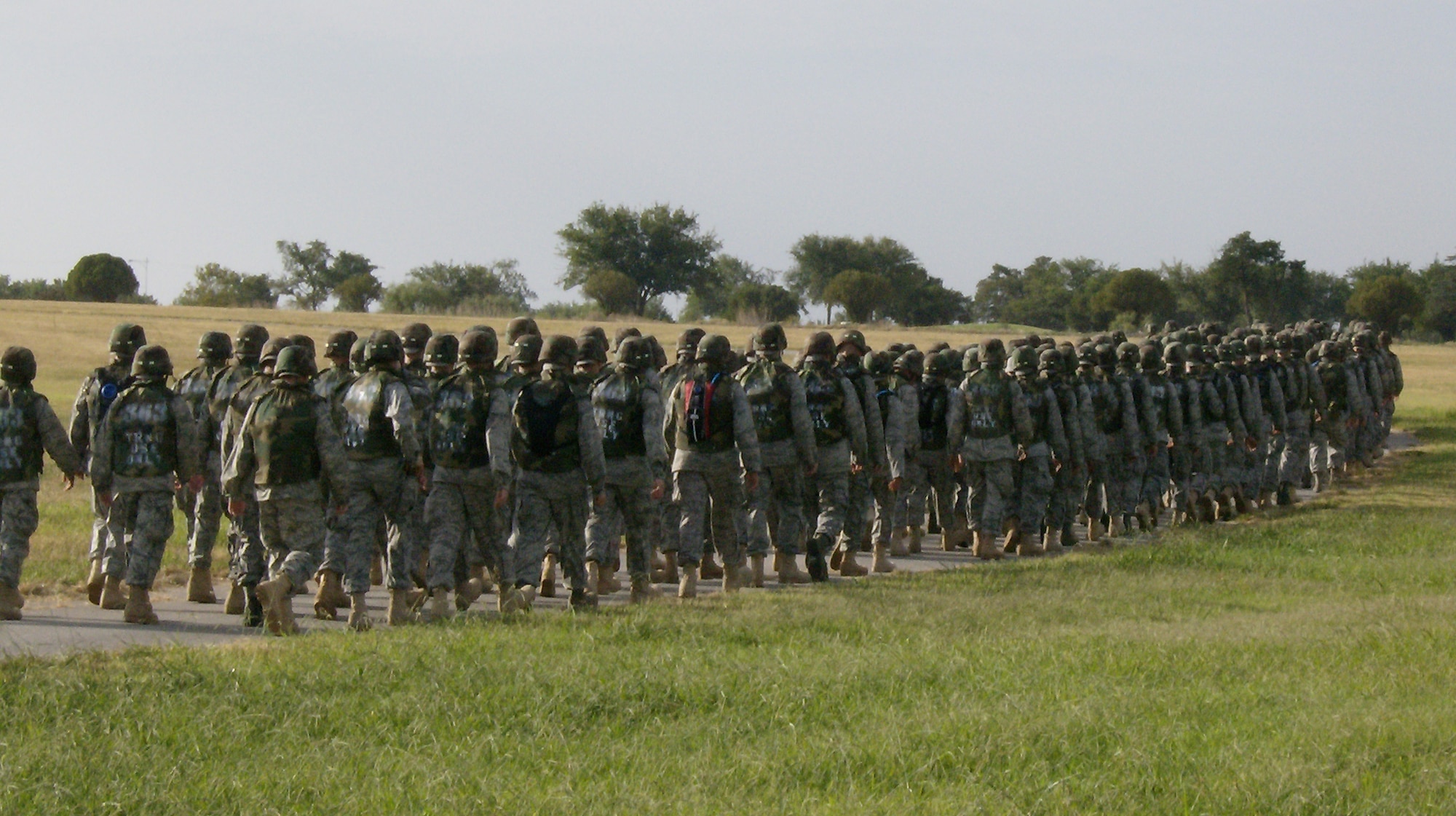Airmen from the 363rd Training Squadron make the 3-mile trek to the 381st Training Squadron's medical readiness site to hone their combat skills, including self-aid and buddy care, loading and unloading wounded personnel and transporting litters through an obstacle course. (U.S. Air Force photo/Airman 1st Class James Bell)