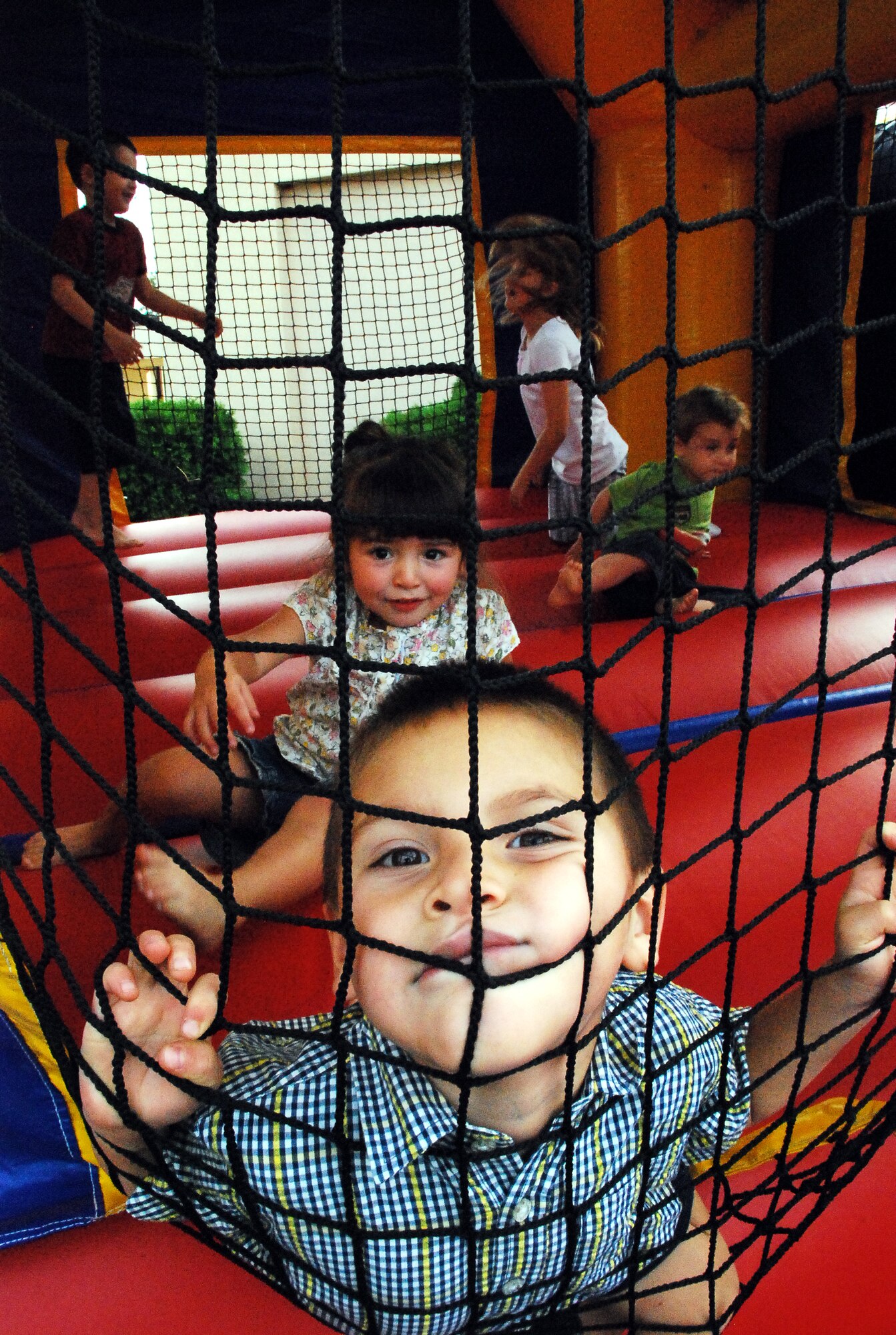 Children enjoy time in the moon bounce during the Air Mobility Command Icon competition Aug. 14 at the McGuire Club. Family, friends, and co-workers came out to support McGuire and Fort Dix members who sang in the competition. (U.S. Air Force photo/Airman 1st Class Bekah Phy)