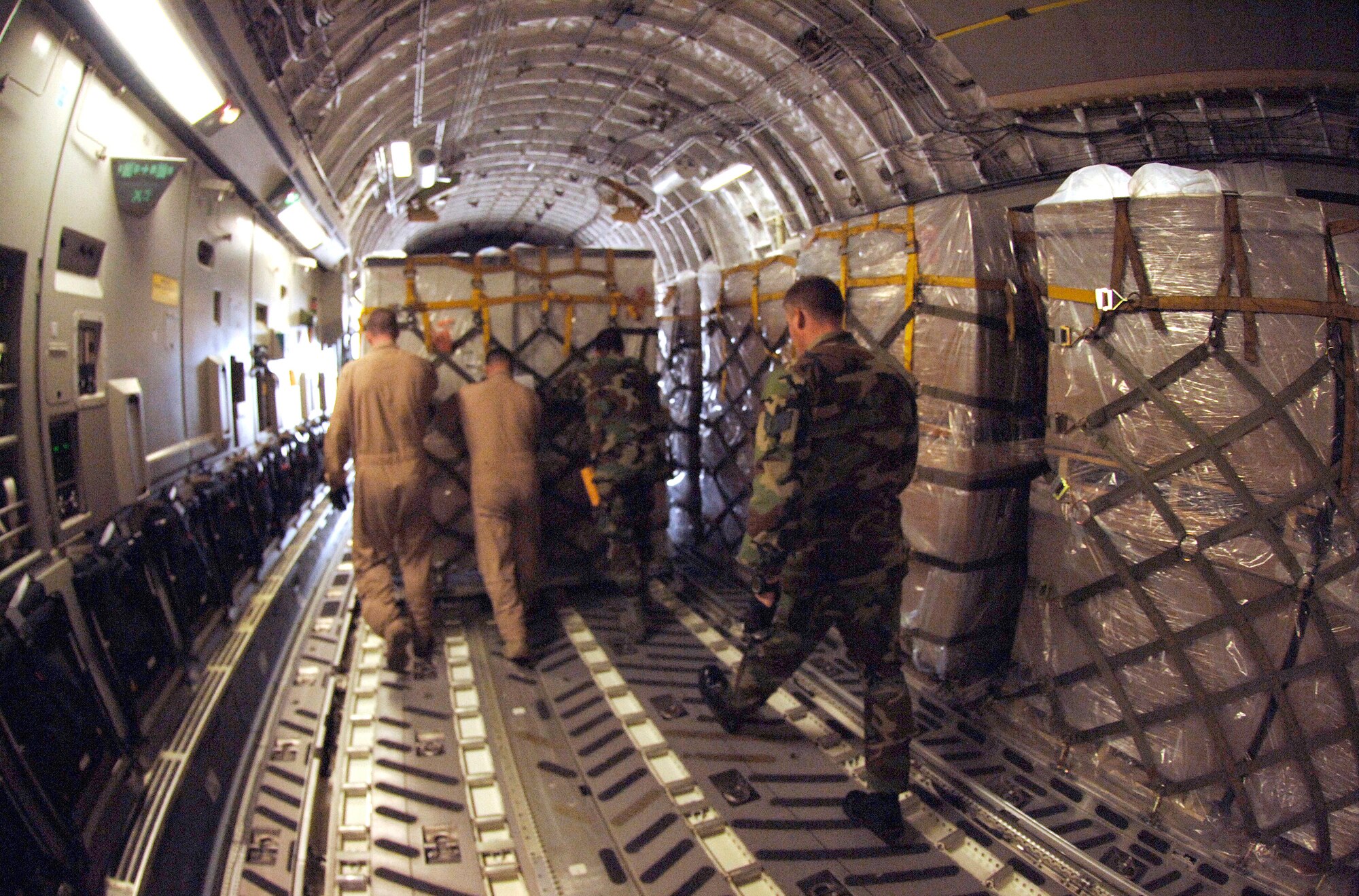 Aerial Transporters Staff Sgt. Chris Droegemueller (right) and Staff Sgt. Jason Tripler assist C-17 Loadmasters Staff Sgt. Kevin Alexander and Staff Sgt. Donald Jones in delivering the second wave of humanitarian aid to the Republic of Georgia, Aug. 14. The delivery was a joint-service effort between U.S. Army Europe Soldiers, U.S. Air Forces Europe and Air Mobility Command Airmen. The Airmen are assigned to the 86th Contingency Response Group at Ramstein Air Base, Germany, and the 6th Airlift Squadron, McGuire AFB, N.J.  (U.S. Air Force photo/Master Sgt. Scott Wagers)