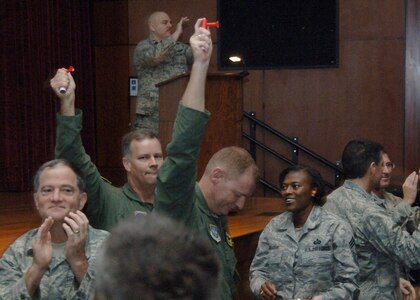 (From left) Brig. Gen. Donald Lustig, Col. Donald L. Schaffer, Col. John "Red" Millander and Chief Master Sgt. Bernise Belcer applaud Team Charleston for obtaining an "Excellent" rating during the Air Mobility Command Operational Readiness Inspection held Aug. 3-10. General Lustig is the inspector general for AMC. Colonel Millander, Colonel Schaffer and Chief Belcer are part of the 437th Airlift Wing leadership at Charleston Air Force Base. (U.S. Air Force photo/Airman 1st Class Timothy Taylor)