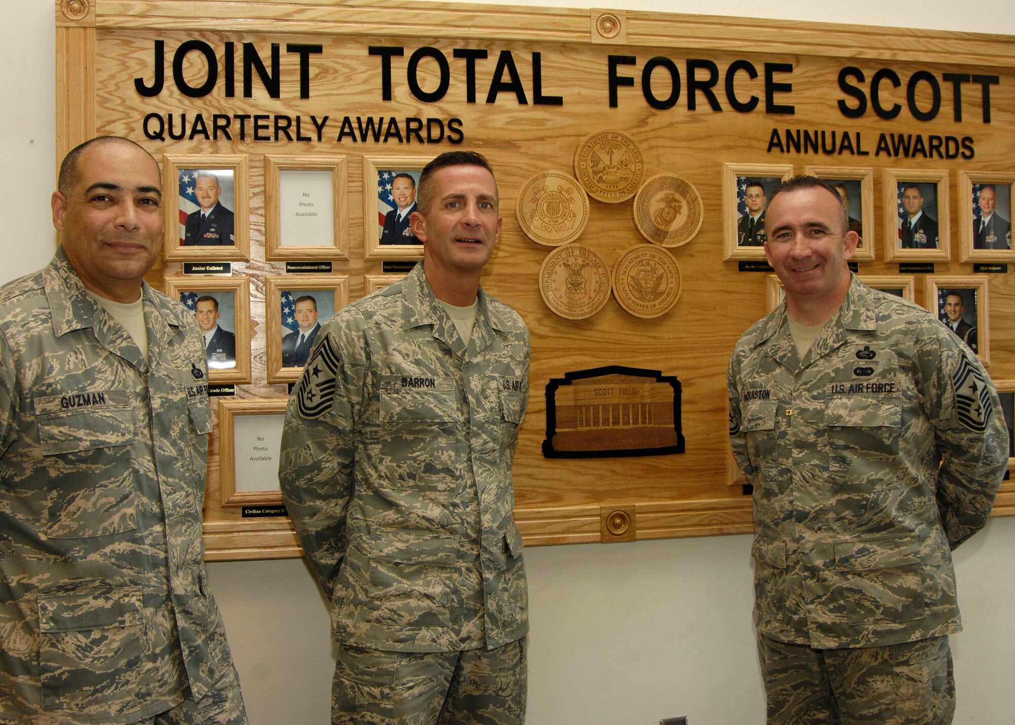 SCOTT AIR FORCE BASE, Ill. -- Chief Master Sgt.  Joseph E. Barron, Air Mobility Command command chief, Chief Master Sgt. Ken Mcquiston, U.S. TRANSCOM command chief, and Chief Master Sgt. Jose Guzman, 375th Mission Support Squadron superintendent gather at the unveiling of the Joint Total Force Scott Awards board at the Base Exchange Aug. 7. 
(US Air Force photo/Senior Airman Mildred Guevara)
