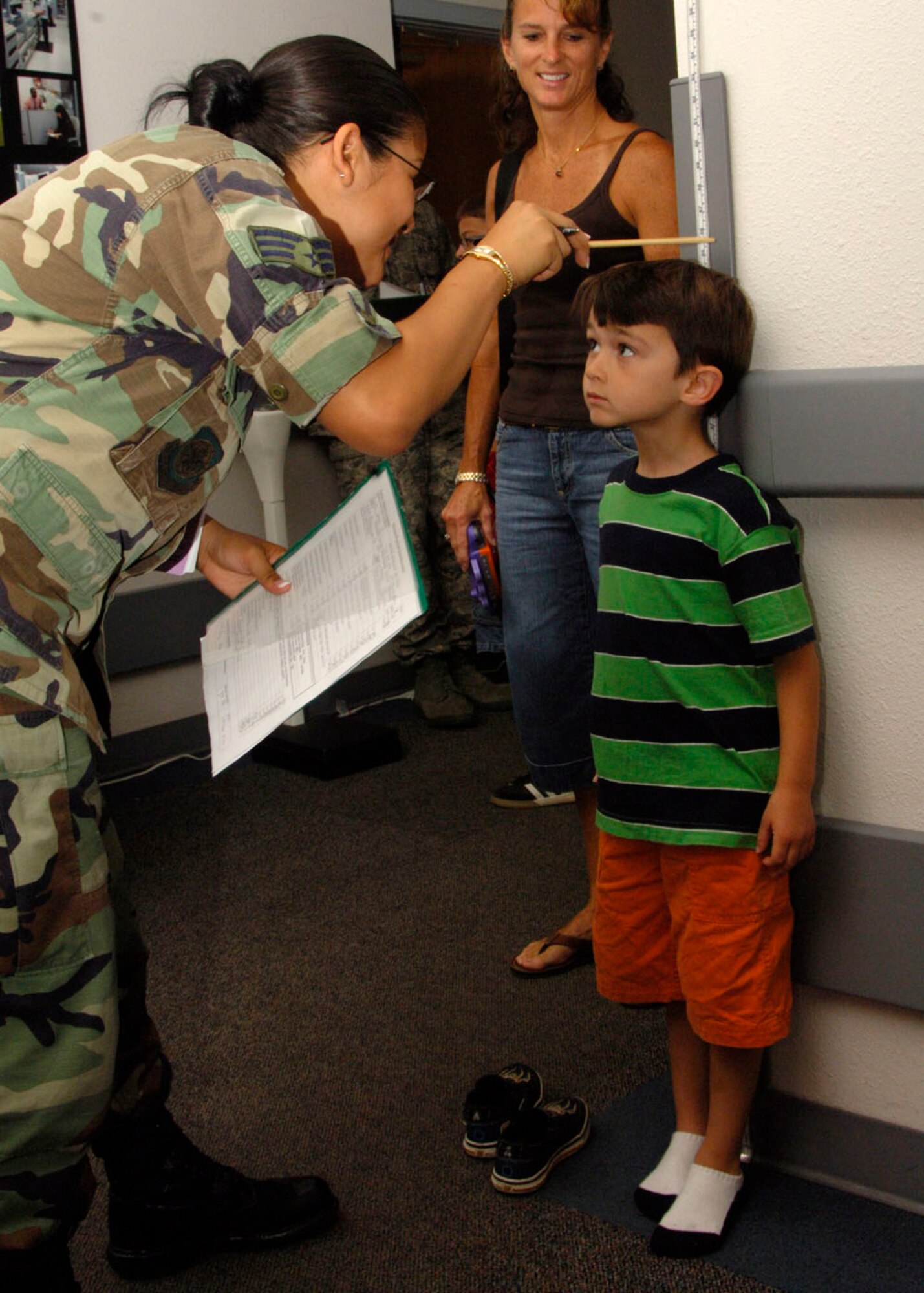 SCOTT AIR FORCE BASE, Ill. -- Senior Airman Christina Canto, 375th Medical Group health services medical technician, takes a height measurement of five-year-old Jared Padilla at the back-to-school health clinic. Jared is the son of Senior Master Sgt. Jose Padilla, 18th Air Force Executive Services superintendent. 
(US Air Force photo/Airman 1st Class Wesley Farnsworth)
