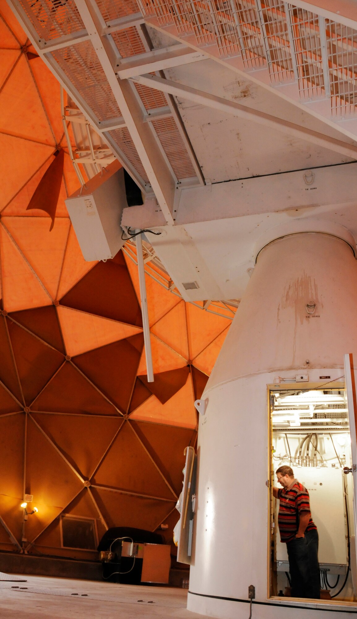 David Jones, Department of Defense Contractor, makes adjustments in the Radome Communication Antenna Aug. 14, 2008 at an undisclosed air base in Southwest Asia.  Mr. Jones is adjusting the dehydrator that supplies constant pressure and humidity to the wave guide, which provides the signal path for reception and transmission through the antenna. (U.S. Air Force photo by Tech. Sgt. Michael Boquette/Released)