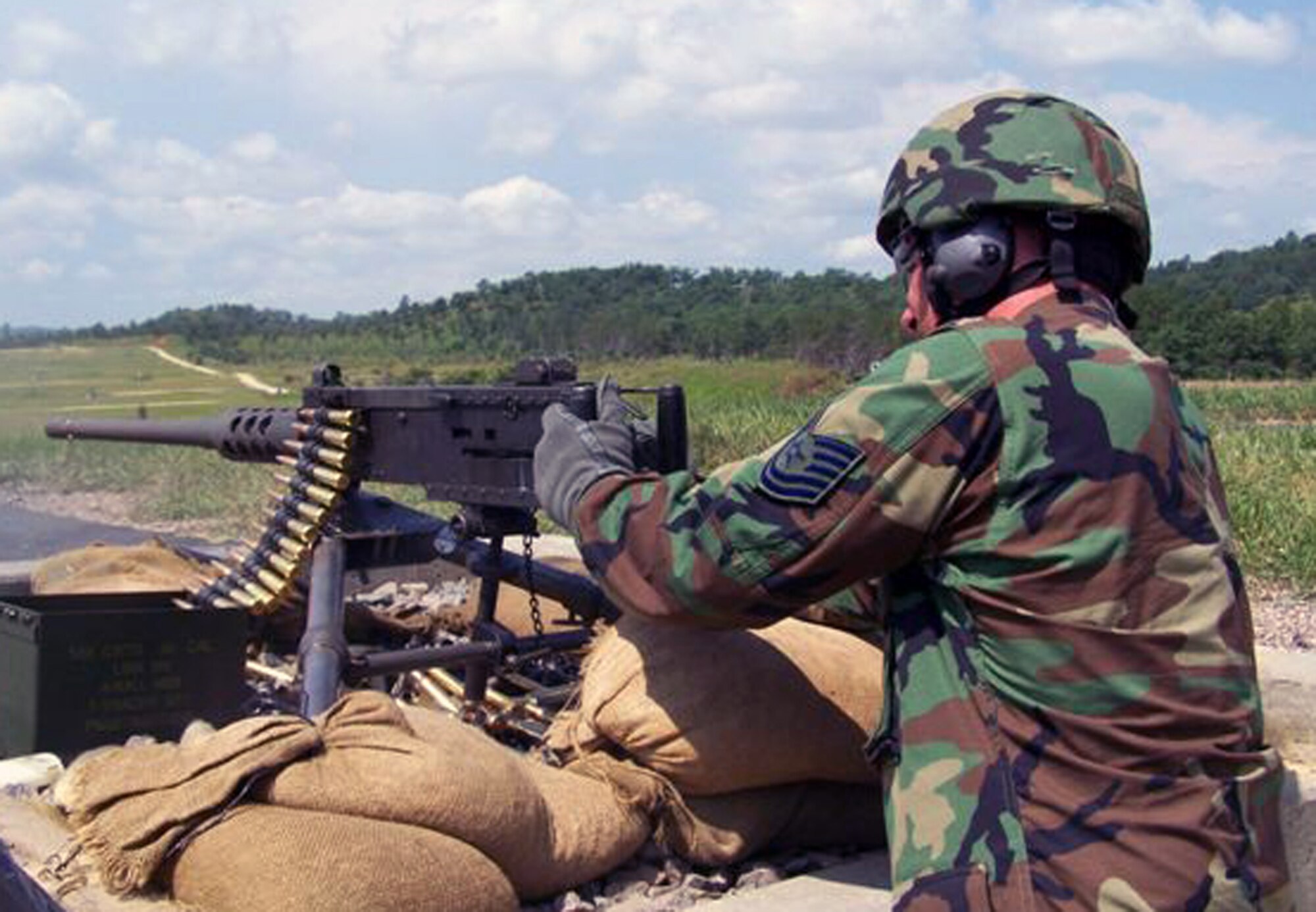 Tech. Sgt. Dean A. Bartlett, 131st Security Forces Squadron combat arms, fires a .50 cal.  Members from 131st Security Forces Squadron helped train four Army units on weapons for an upcoming deployment.