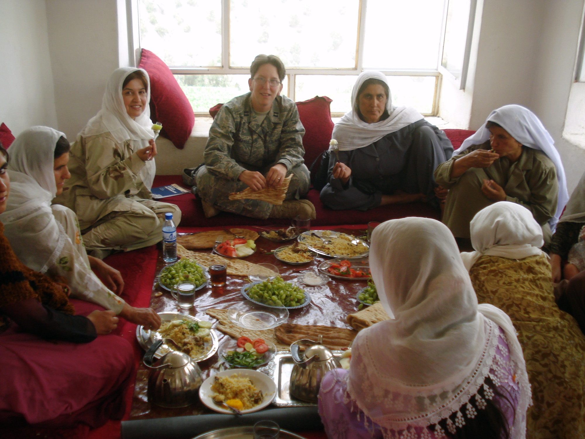 A group of Afghan women and Capt. Jillian Torango from the Panjshir Provincial Reconstruction Team, participate in a women's shura in Sangee Village, Anaba District, Afghanistan, Aug. 4. Approximately 100 women attended and discussed their issues with the Panjshir PRT Woman's Affairs team. (Courtesy photo) 
