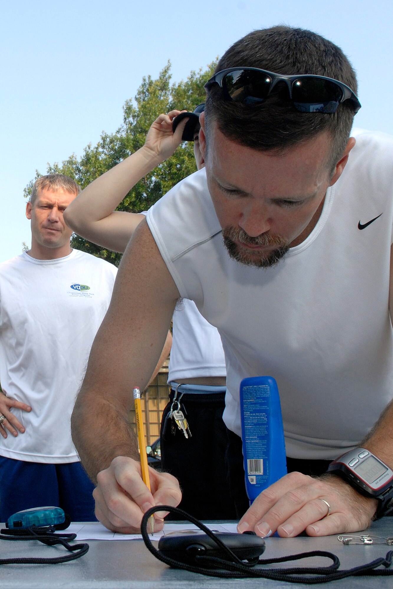 LANGLEY AIR FORCE BASE, Va. --  Paul Pelletier, 735th Supply Chain Management Group contractor, signs an accountablity sheet to represent his team in a duathlon sponsored by the 1st Force Support Squadron Aug. 15.  A duathlon is an eight mile exercise designed to challenge each participant's physical endurance with cycling and running.  The 1st FSS organizes an event monthly to continue encouraging physical fitness as the Air Force exercises the fit to fight mentality.  (U.S. Air Force photo/Senior Airman Vernon Young)