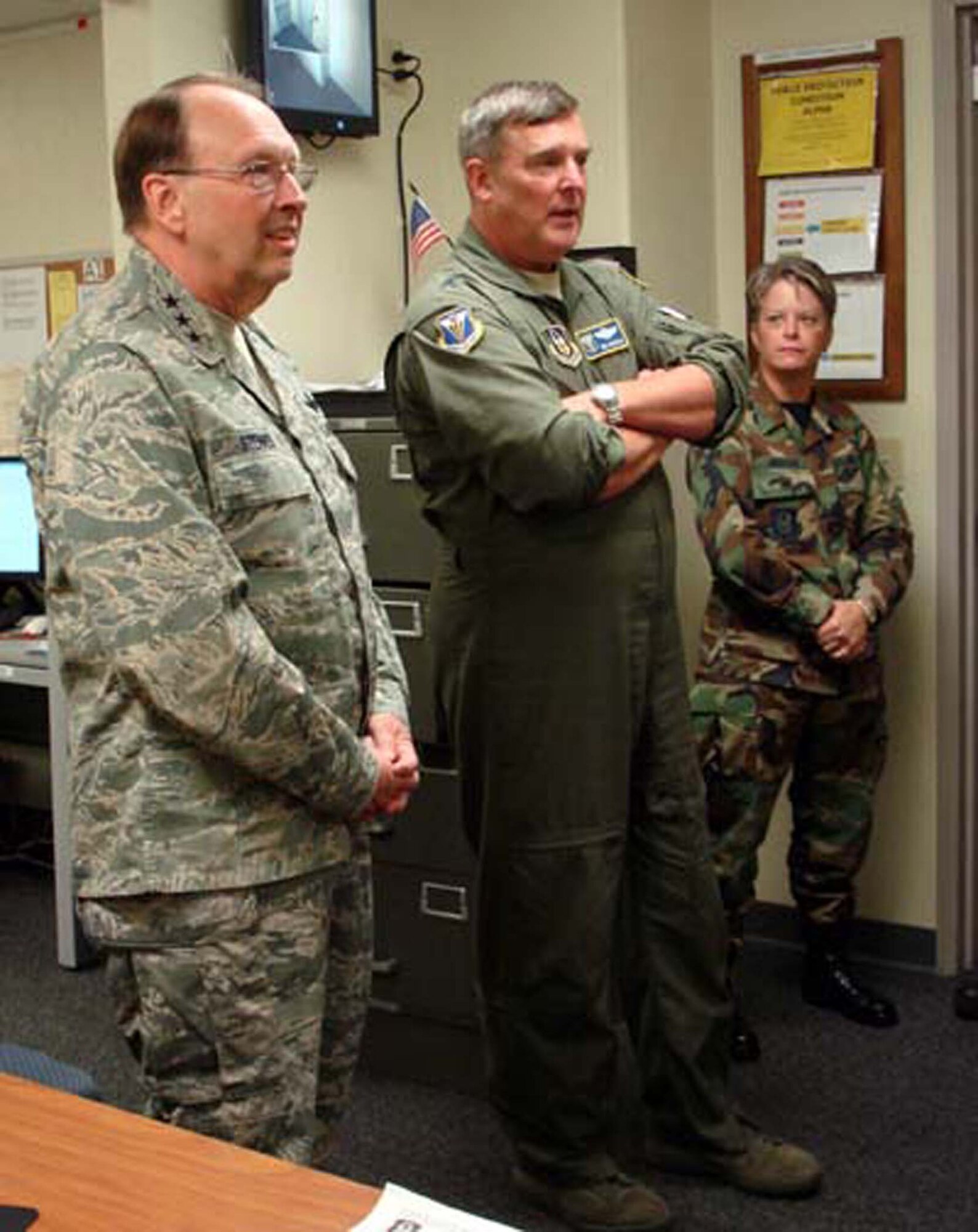 Lt. Gen. Charles E. Stenner Jr., Chief and Commander, Air Force Reserve Command, listens as Maj. Gen. Robert E. Duignan, Fourth Air Force Commander, explains operations of the numbered Air Force's Crisis Action Team, while Maj. Maureen McAllen, 4AF Executive Officer looks on.  (U.S. Air Force photo/MSgt. Linda E. Welz)