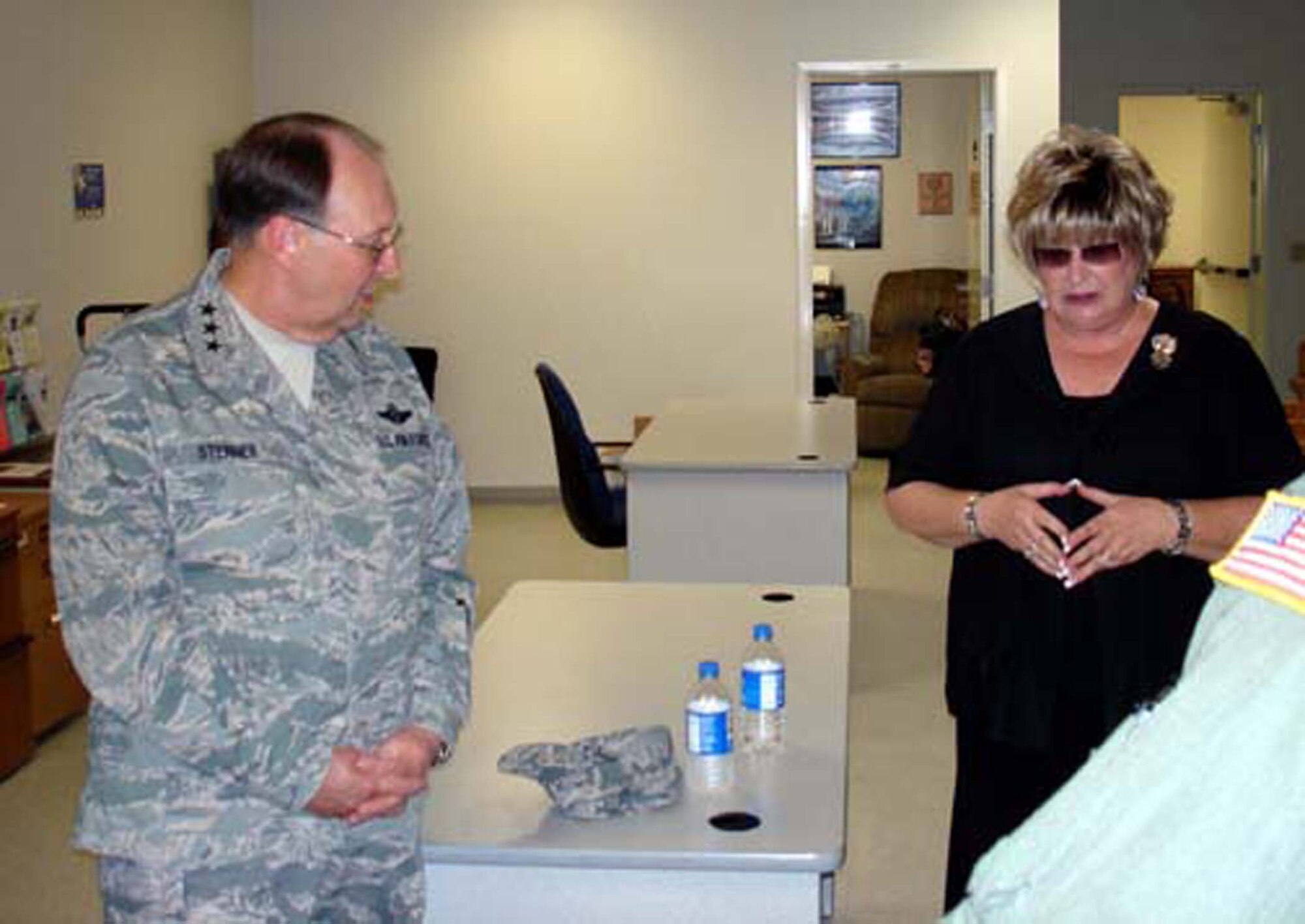 Lt. Gen. Charles E. Stenner Jr., listens as Ms. Laura Froelich explains procedures at the Marine deployment center, March ARB, Calif.  The general stopped by the center during his August 6, 2008 visit to March Field.  (U.S. Air Force photo/Maj. Andra P. Higgs)