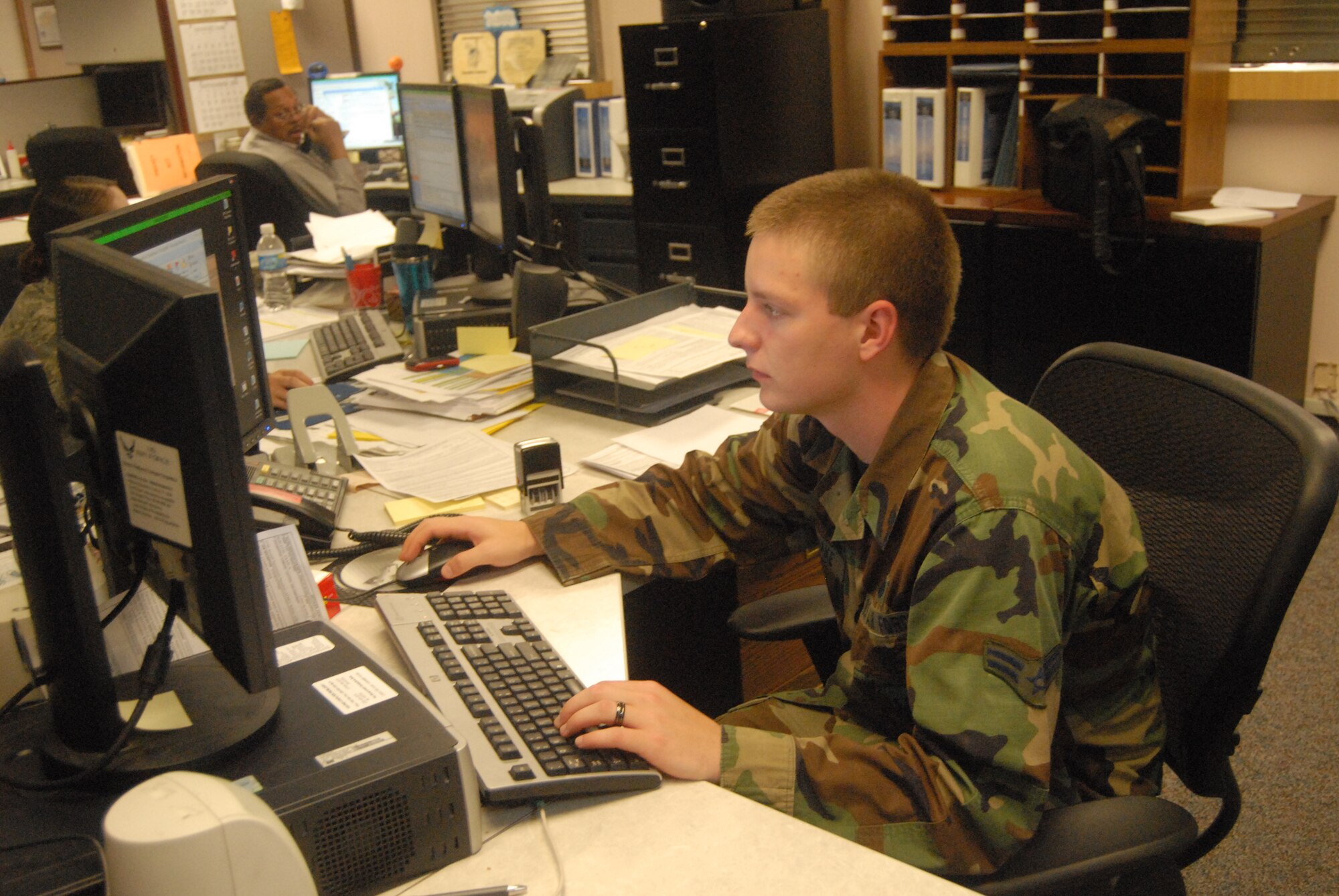 Airman 1st Class Russell Rasnake, 43rd Security Forces Squadron, works to input Airmen evaluations into Pope's personnel tracker Monday. (U.S. Air Force Photo by Emily Smith)