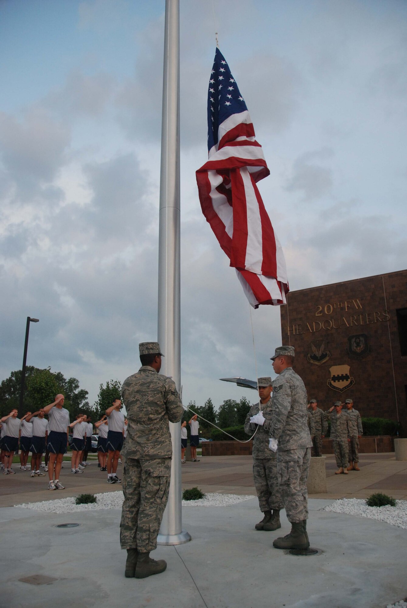SHAW AIR FORCE BASE, S.C. -- Members of Shaw's Honor Guard raise the flag for the first time on the new 20th Fighter Wing flagpole during a reveille ceremony Aug. 15. Col. James Post, 20th FW commander, leads the ceremony on the 61st anniversary of the 20th FW. (U.S. Air Force photo/Senior Master Sgt. Brad Fallin)