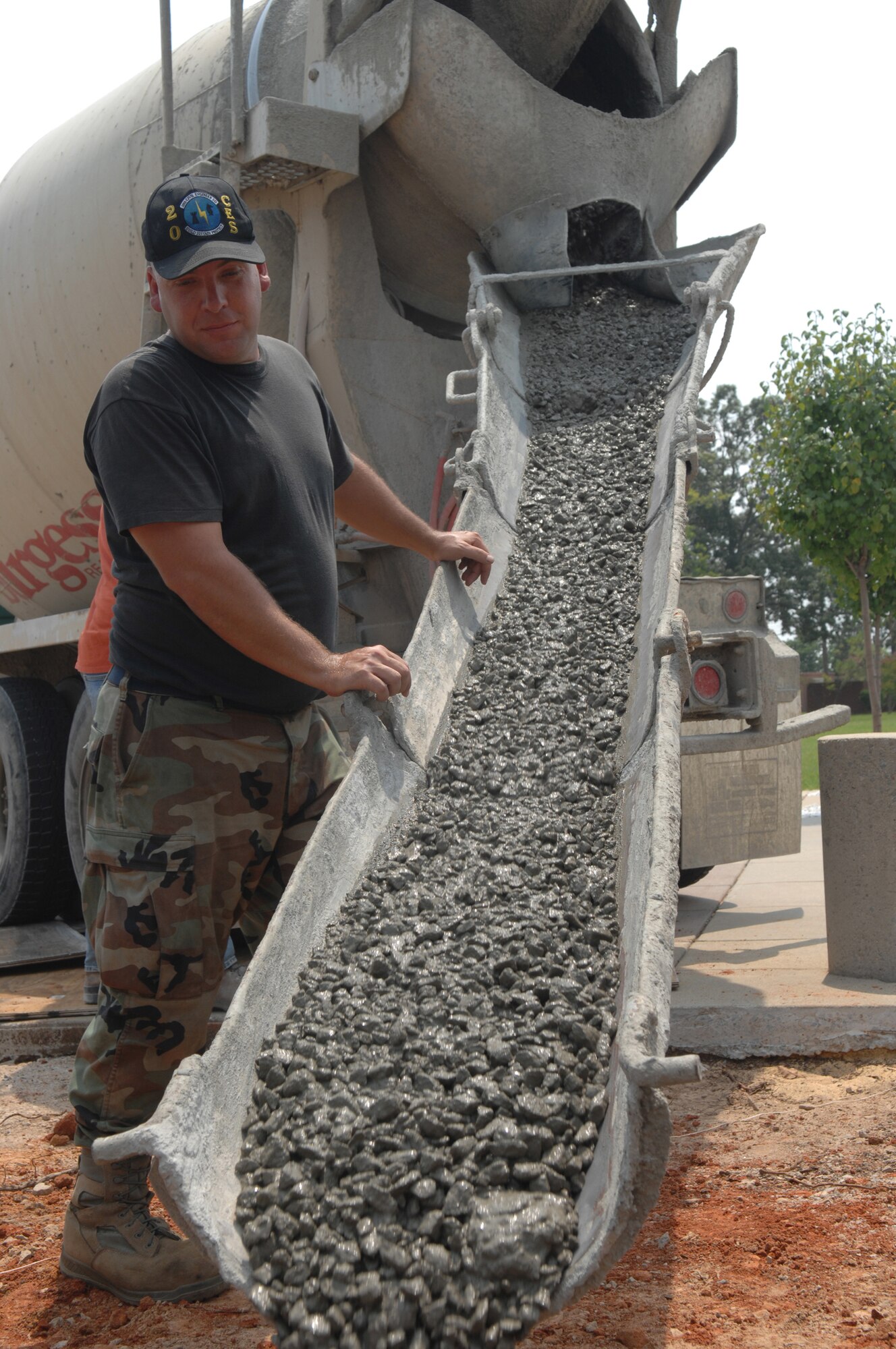 SHAW AIR FORCE BASE, S.C. -- Staff Sgt. David Mitchell, 20th Civil Engineer Squadron "Dirtboyz" heavy equipment operator, guides wet concrete for a flag base August 5. The "Dirtboyz" are constructing a new Shaw flag for the 20th Fighter Wing headquarters. The project is scheduled for completion August 15.   (U.S. Air Force photo/Staff Sgt. Nathan Bevier)