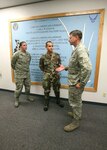 8/13/2008 - Brig. Gen. Len Patrick, 37th Training Wing commander, talk with Airmen 1st Class Shelly Kerstanski and Ingemar Peralta, 37th Mission Support Squadron, about the Airman's Creed mural they painted at the military personnel flight. (USAF photo by Robbin Cresswell)