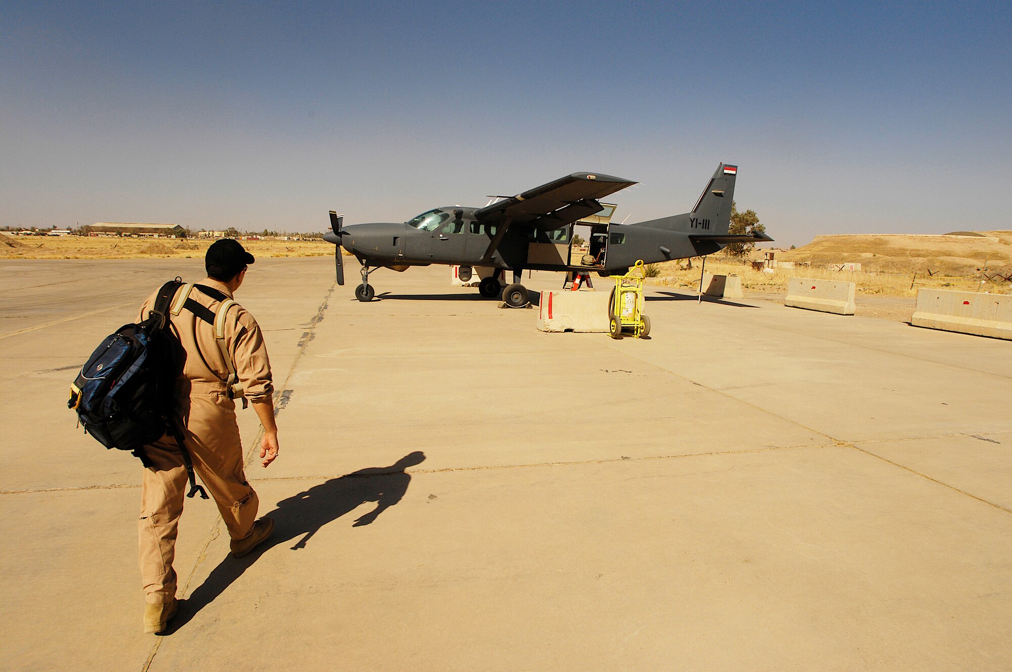 Major Thagel, an Iraqi air force pilot walks to a Iraqi C-208 Cessna Caravan for his last training ride befor he becomes a mission commander or pilot.  (U.S. Air Force photo by SSgt. Aaron Allmon)
