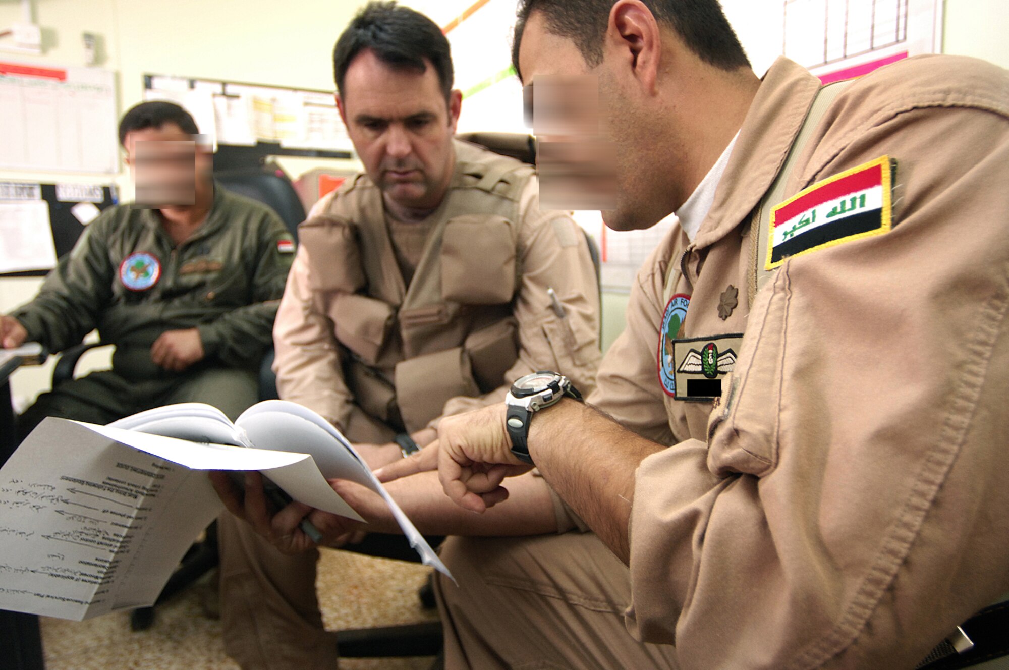 Iraqi pilots give a pre-flight brief to U.S Air Force Lt. Col. Terry Wheeler, 870th Air Expeditionary Advisory Squadron Kirkuk Regional Air Base, Iraq, prior to a training flight. Lt. Col. Wheeler is an instructor pilot training Iraqi pilots to fly the C-208 Cessna Caravan. The Caravan is equipped with a surveillance package used to collect intelligence surveillance and reconnaissance information. (U.S. Air Force photo illustration by Staff Sgt. Aaron Allmon)