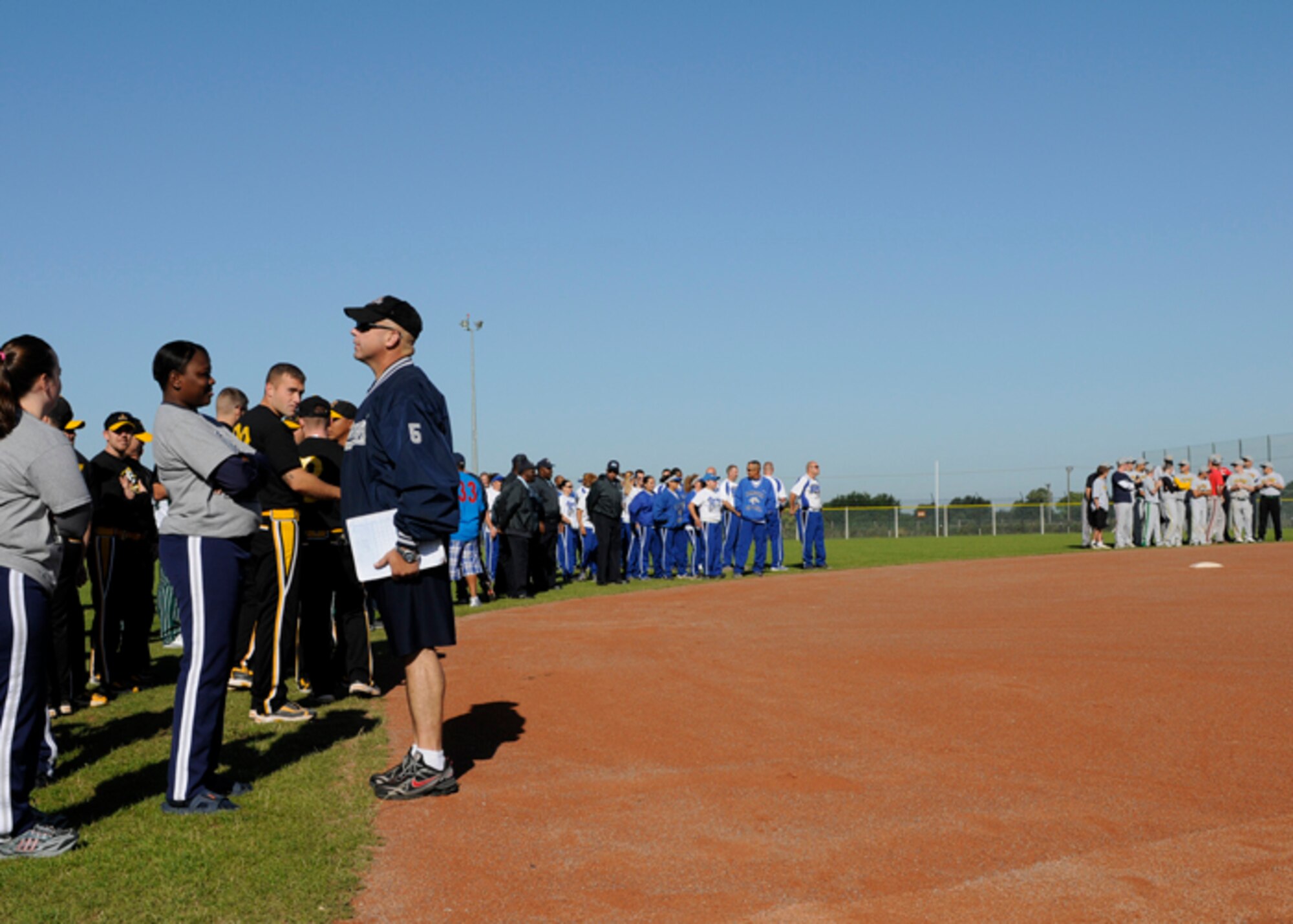 Teams from around USAFE line the baseball diamond during the opening ceremony of the USAFE Softball Tournament Aug. 14 at RAF Lakenheath, England. The top two men and women Air Force teams will compete in the Army/Air Force Softball Championships Aug. 21 to 24 at Grafenwoher, Germany. (U.S. Air Force photo by Airman 1st Class Torri K. Larson)