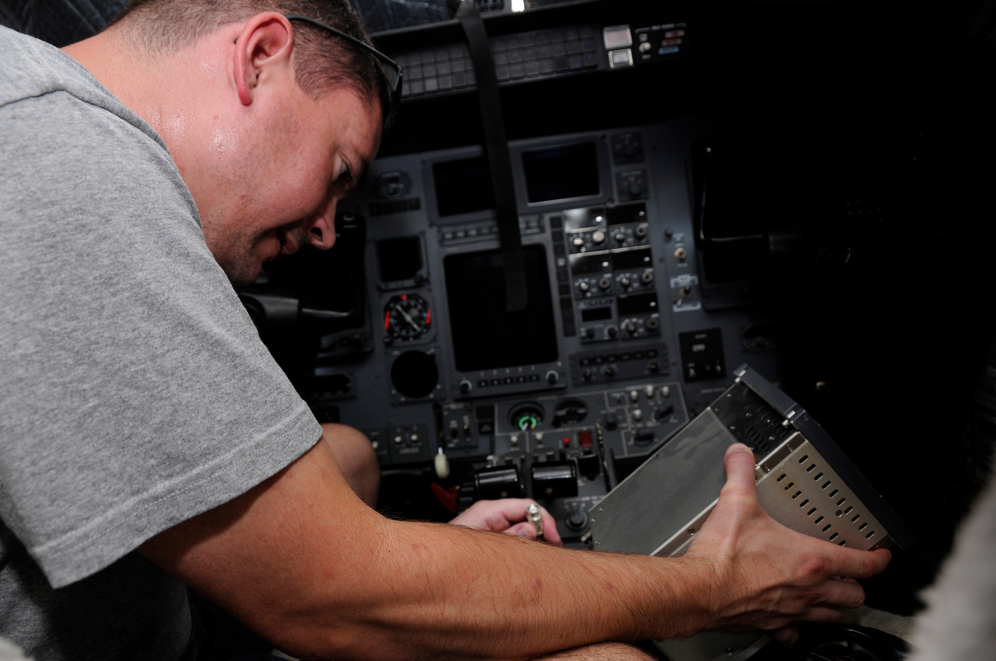 SOUTHWEST ASIA -- Bryan Turner, a civilian aircraft mechaniac, installs a flight management unit in the U.S. Marine Corps Cessna Citation Encore, UC 35D aircraft Aug. 8. The UC-35D is a state-of-the-art twin turbofan aircraft. Mr. Turner is employed by Dynacorp to maintain and service the aircraft. (U.S. Air Force photo by Tech. Sgt. Michael Boquette)