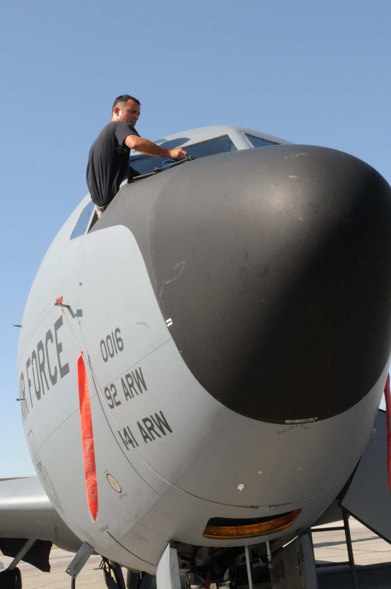 08/13/2008 - MANAS AIR BASE, KYRGYZ REPUBLIC --  Senior Airman Abraham Almonte, 376th Expeditionary Aircraft Maintenance Squadron crew chief, cleans the windows of a KC-135 Stratotanker here, Aug 13. The 376th Air Expeditionary Wing and serves as the premier air mobility hub for the International Security Assistance Force and Coalition military operations in Afghanistan. (Air Force photo / Airman 1st Class Ruth Holcomb)
