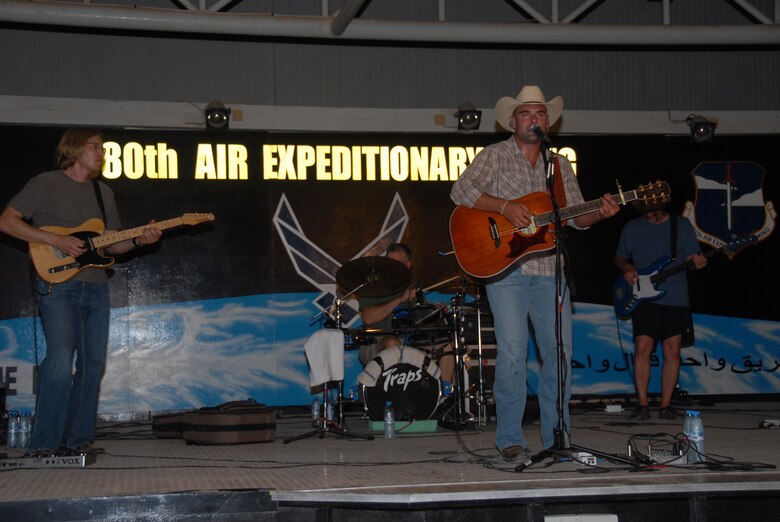 SOUTHWEST ASIA--King Cone Band plays various country music medleys for the 380th Air Expeditionary Wing in the night heat at the Thirsty Camel Pavilion Aug. 13. The band is performing as part of the Armed Forces Entertainment to help uplift the morale of deployed military members.(U.S. Air Force photo/Tech. Sgt. Christopher A Campbell)(released)