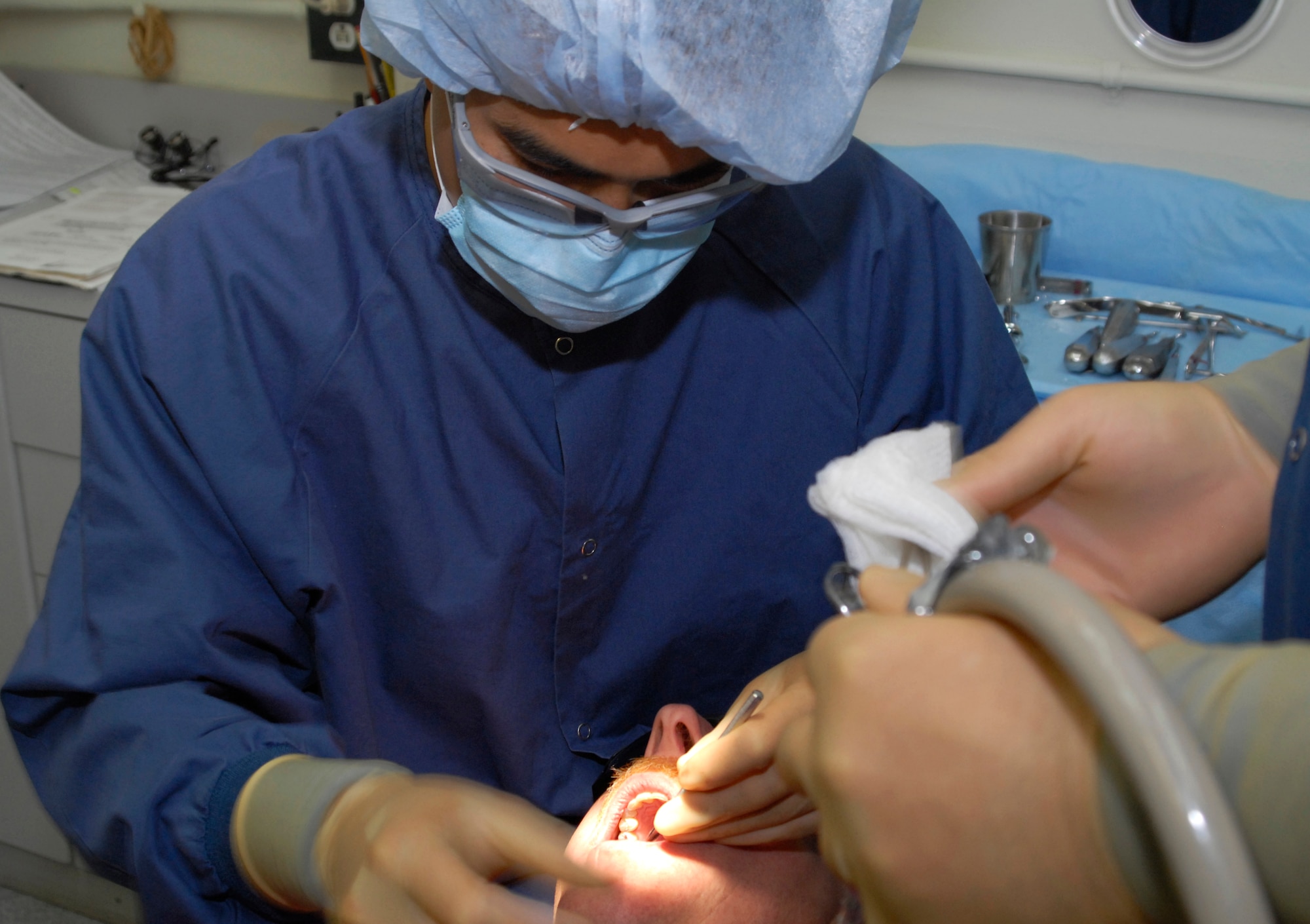 KUNSAN AIR BASE, Republic of Korea -- Capt. (Dr.) James Young, a dentist with the 8th Medical Operations Squadron, carries out an examination on a patient here Aug. 14 Aug.  (U.S. Air Force photo by Senior Airman Dana Hill)