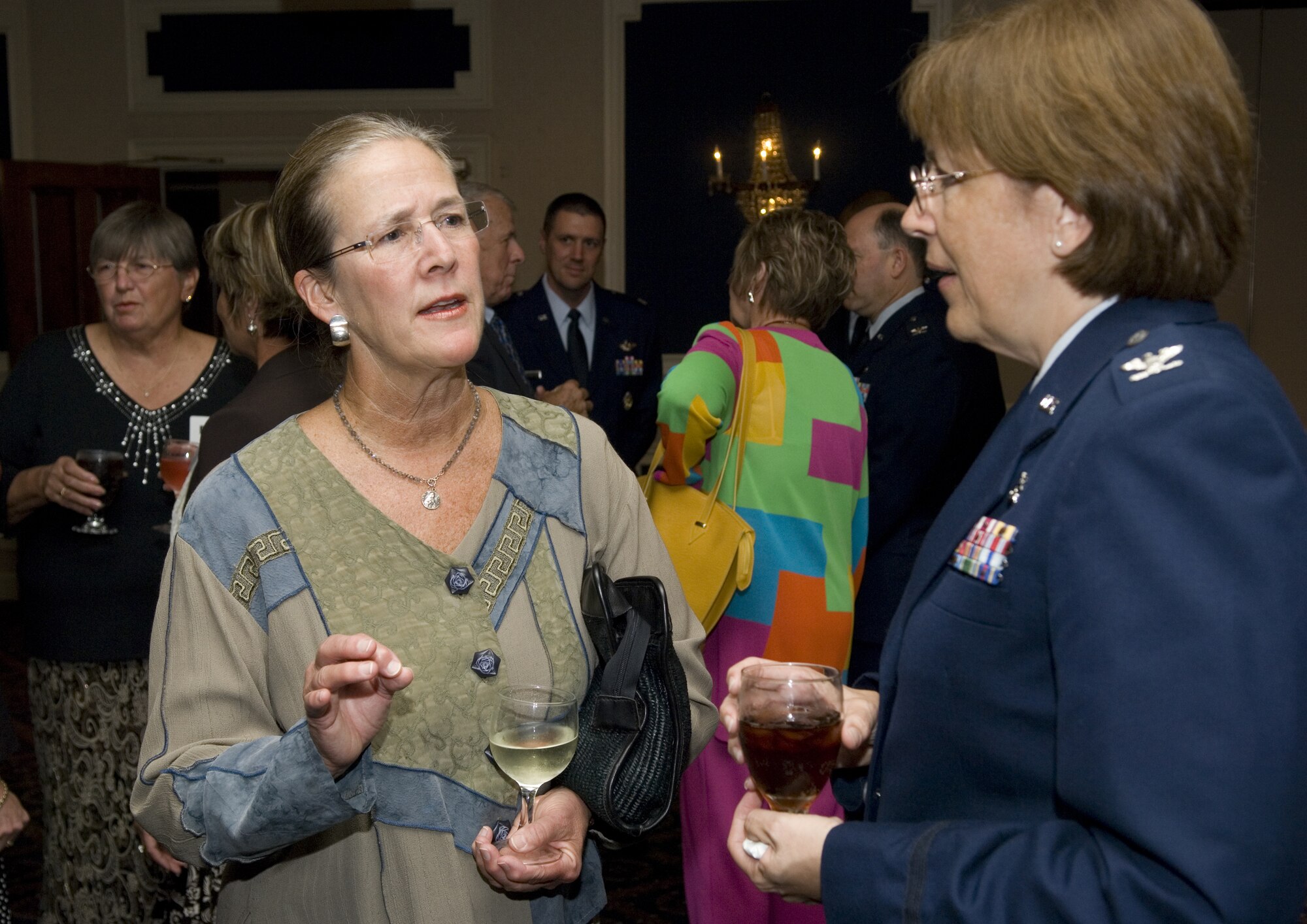 Dr. Michelle Knolla and Col. Linda Eaton talk during the Ten Dinner Aug. 14 in the Patriot's Club at Offutt Air Force Base, Neb. Dr. Knolla is an obstetrician/gynecologist  with the Methodist Physician Clinic and  Colonel Eaton is the commander of the Ehrling Bergquist Clinic at Offutt AFB. (U.S. Air Force photo/Lance Cheung)