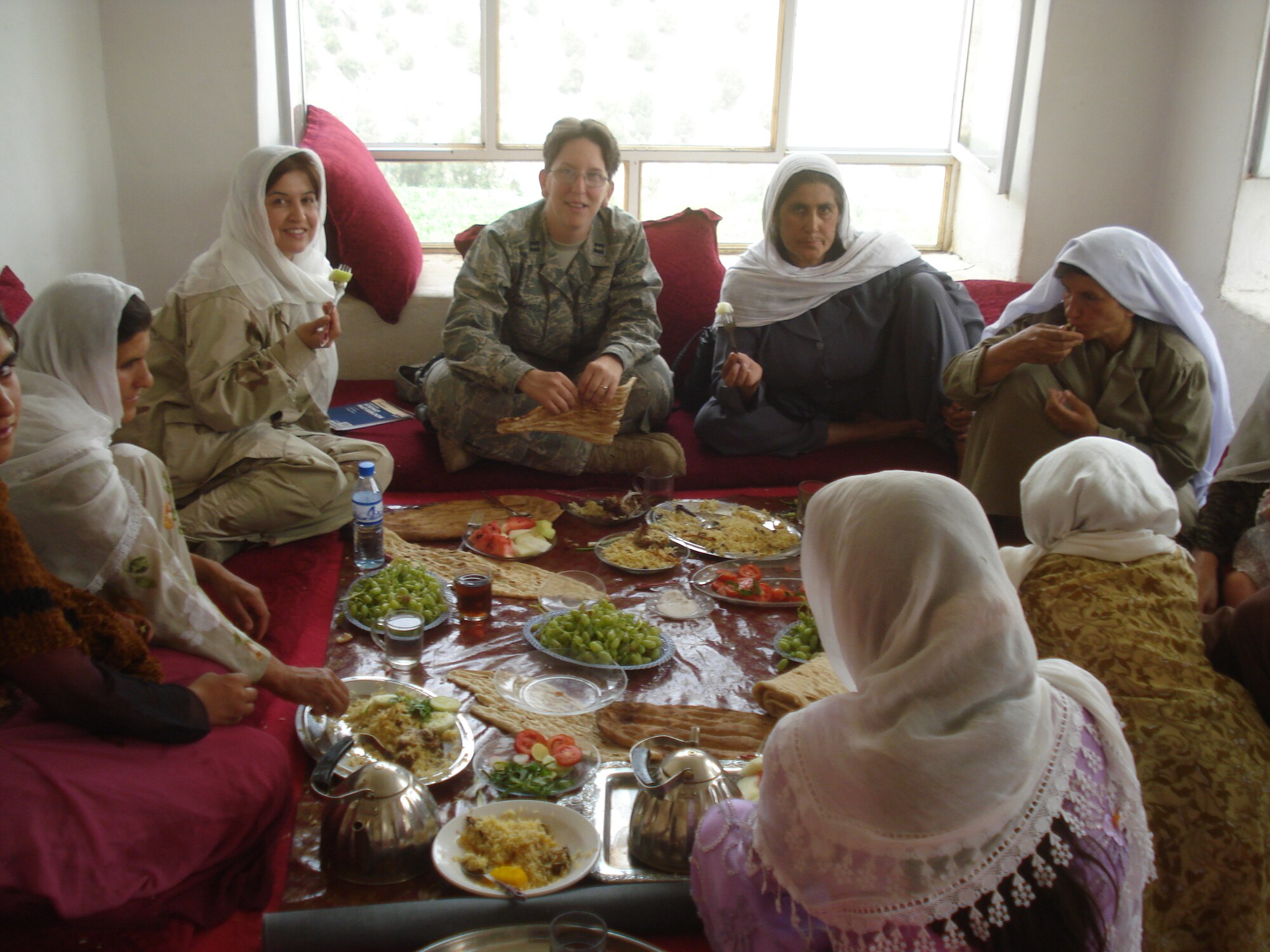 A group of Afghan women and Air Force Capt. Jillian Torango of the Panjshir Provincial Reconstruction Team, participate in a Women’s Shura in Sangee Village, Anaba District, Afghanistan, Aug. 4.  Approximately 100 women attended and discussed their issues with the Panjshir PRT Woman’s Affairs team. (Courtesy photo)