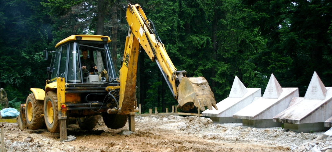 A Bosnian Backhoe Operator Assists Members Of The Maryland Air National