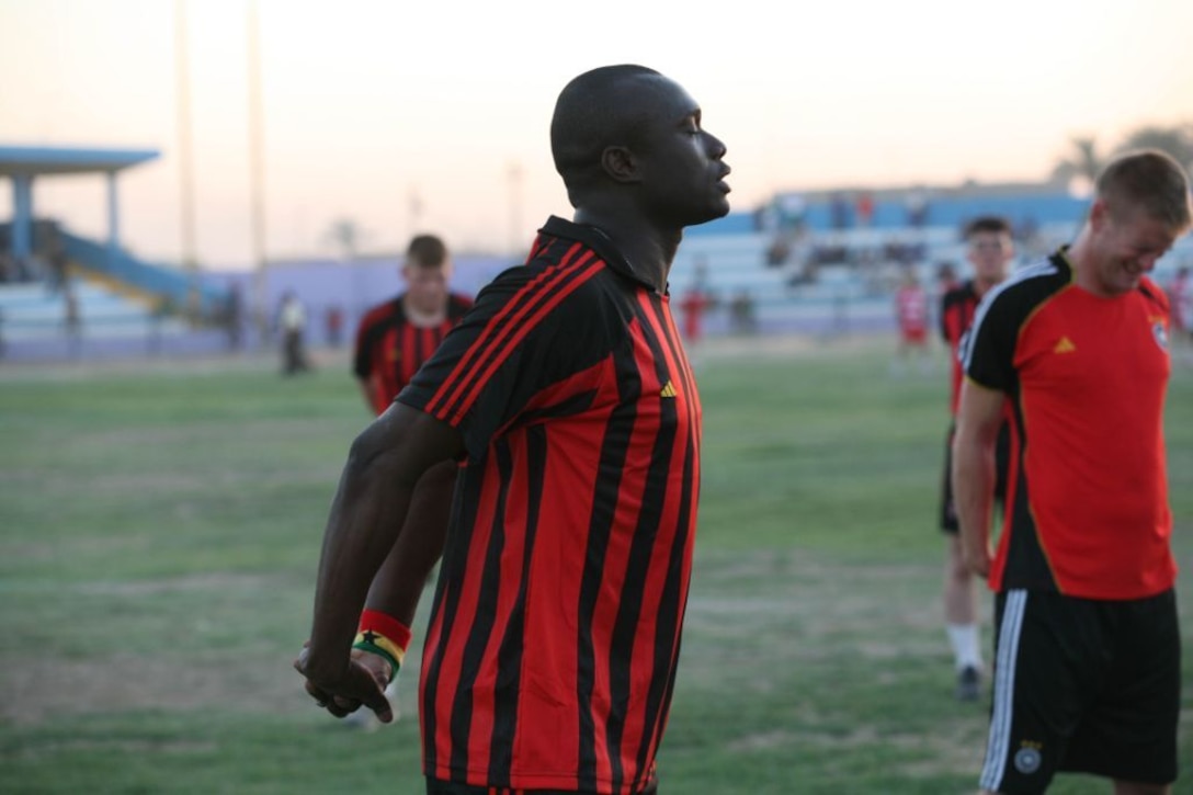 RAMADI, Iraq (August 15, 2008) –Sgt. Atta K. Gyamfi,  a motor vehicle operator with 1st Battalion, 9th Marine Regiment, Regimental Combat Team 1, stretches before playing in the Marines versus Iraqi Police soccer game at the Mulaab Stadium in Ramadi August 14. The Ramadi Soccer Tournament ended with a spirited hour and a half soccer game between the Marines and IPs. The IPs won the game 2-0, but according to Col. Hattim Hamid, the Mulaab Iraqi Police Chief, the final score was irrelevant as the game had a more momentous, symbolic meaning. “The game was entertaining but it really didn’t matter who was victorious,” Hattim said. “The only thing that mattered was that the Marines and Iraqi Police came together as brothers and the city of Ramadi came together as one.” (Official U.S. Marine Corps photo by Lance Cpl. Casey Jones)
