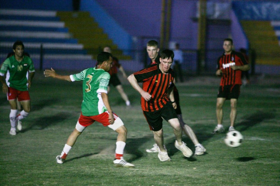 RAMADI, Iraq (August 15, 2008) – 2nd Lt. Andrew Walsh, a team leader with Civil Affairs Detachment 2, 1st Battalion, 9th Marine Regiment, Regimental Combat Team 1, competes in a game of soccer with fellow U.S. service members versus the Ramadi Iraqi Police August 14.  The Iraqi Police won the game 2-0. But according to Col. Hattim Hamid, the Mulaab station Iraqi Police chief, the final score was irrelevant as the game had a more momentous, symbolic meaning. “The game was entertaining but it really didn’t matter who was victorious,” Hattim said. “The only thing that mattered was that the Marines and Iraqi Police came together as brothers and the city of Ramadi came together as one.” (Official U.S. Marine Corps photo by Sgt. Jeremy M. Giacomino) (RELEASED)