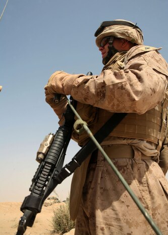 JOINT SERVICE STATION ZEIMER, Iraq (August 15, 2008) – Cpl. Carl Barnett, a field radio operator with Company A, Task Force 1st Battalion, 2nd Marine Regiment, Regimental Combat Team 1, assembles an antenna for one of the many field radios he operates Aug 15. Without the skill and knowledge of a Marine field radio operator, the task of relaying time sensitive and pertinent information would not be successful. (Official U.S. Marine Corps photo by Lance Cpl. Scott Schmidt)
