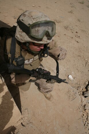 JOINT SERVICE STATION ZEIMER, Iraq (August 15, 2008) – Cpl. Carl Barnett, a field radio operator with Company A, Task Force 1st Battalion, 2nd Marine Regiment, Regimental Combat Team 1, talks with a member of an adjacent unit Aug. 15. Without the skill and knowledge of a Marine field radio operator, the task of relaying time-sensitive and pertinent information would not be possible. (Official U.S. Marine Corps photo by Lance Cpl. Scott Schmidt)