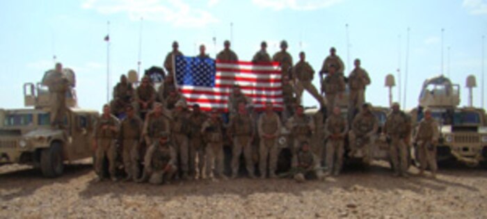 Members of Mobile Assault Platoon, Regimental Combat Team 5, known as Grizzly Mobile, pose for a picture Aug. 14 in al-Anbar province, Iraq, during their mission to support 2nd Light Armored Reconnaissance Battalion, RCT-5. Marines with Grizzly Mobile usually conduct escort missions for RCT-5 personnel, but they recently assisted 2nd LAR Bn. to extend its patrolling capabilities. The Marines helped set up vehicle checkpoints on the highway and in the desert. They also worked in conjunction with 2nd LAR Bn. in apprehending several detainees, one of whom turned out to be wanted for insurgent activity. ::r::::n::